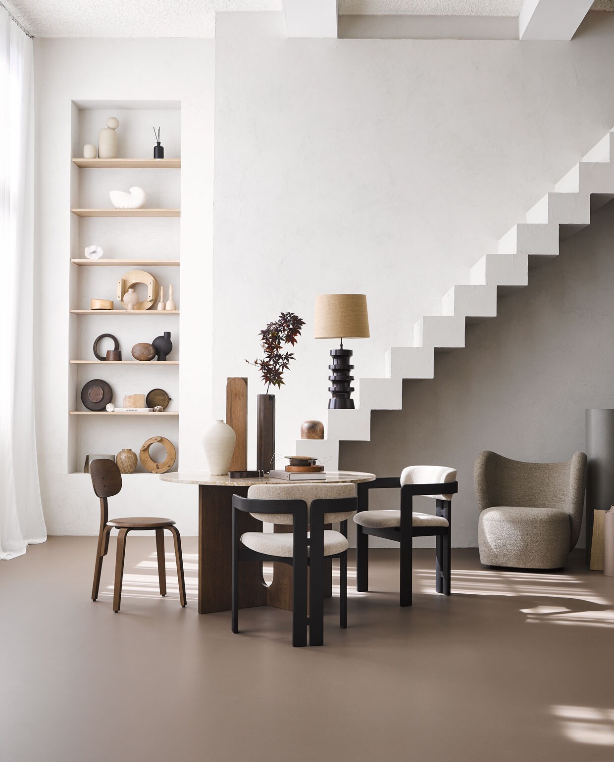 Marmoleum vloer kleur Leem, per m² € 48M.m.v. menuspace.com (eettafel van Menu, bruine stoel), edha-interieur.nl (eetkamerstoelen van Gallotti &amp; Radice), norr11.com (fauteuil Little Big Chair), ethnicraft.com (bank), prinsheerlijkantiek.nl (houten hoedenmallen, houten lampenvoet), domedeco.com (houten vazen op tafel), studiomilo.nl (trap), byjoa.nl (vaas van keramiek op tafel). Overig privébezit. JA | vtwonen 08-2022 | styling Cleo Scheulderman | fotografie Alexander van Berge | productie Tanja Saarberg