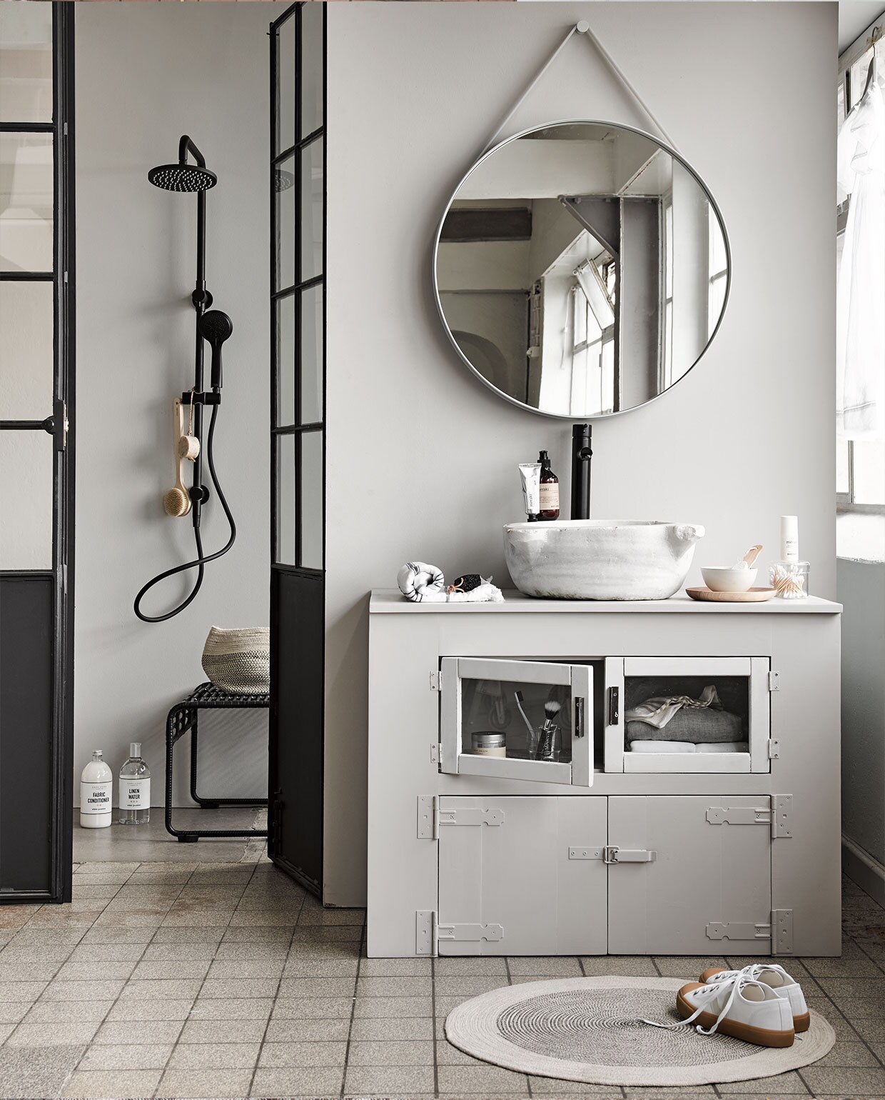 Wasbak met afvoer € 500,-, openslaande deuren € 1850,- (Jan van IJken Oude Bouwmaterialen). Wastafelmeubel prijs op aanvraag (Combitex). Kraan € 249,-, douche € 629,- (Mastello). Spiegel van Hay € 219,-, zeeppomp € 18,95, handcrème € 17,95, kruk House Doctor € 185,-, zwart-witte handdoek € 29,95, borstel € 24,95, rond zeepblok € 11,95, zwarte pedicuresteen € 6,95 (vtwonen.nl). Linnenwater € 12,99 (Zara Home). Mand € 14,99, kleed € 24,99, glazen bakje € 9,99 (H&amp;M Home). Schoenen € 99,99, sokken € 16,-, tandpasta € 4,90 (Six and Sons). Geurkaars € 22,50 (MaisonNL). Houten bord € 17,50, kommetje € 17,50 (Sukha Amsterdam). Overig privébezit. vtwonen 07-2018 | fotografie Alexander van Berge | styling Liza Wassenaar