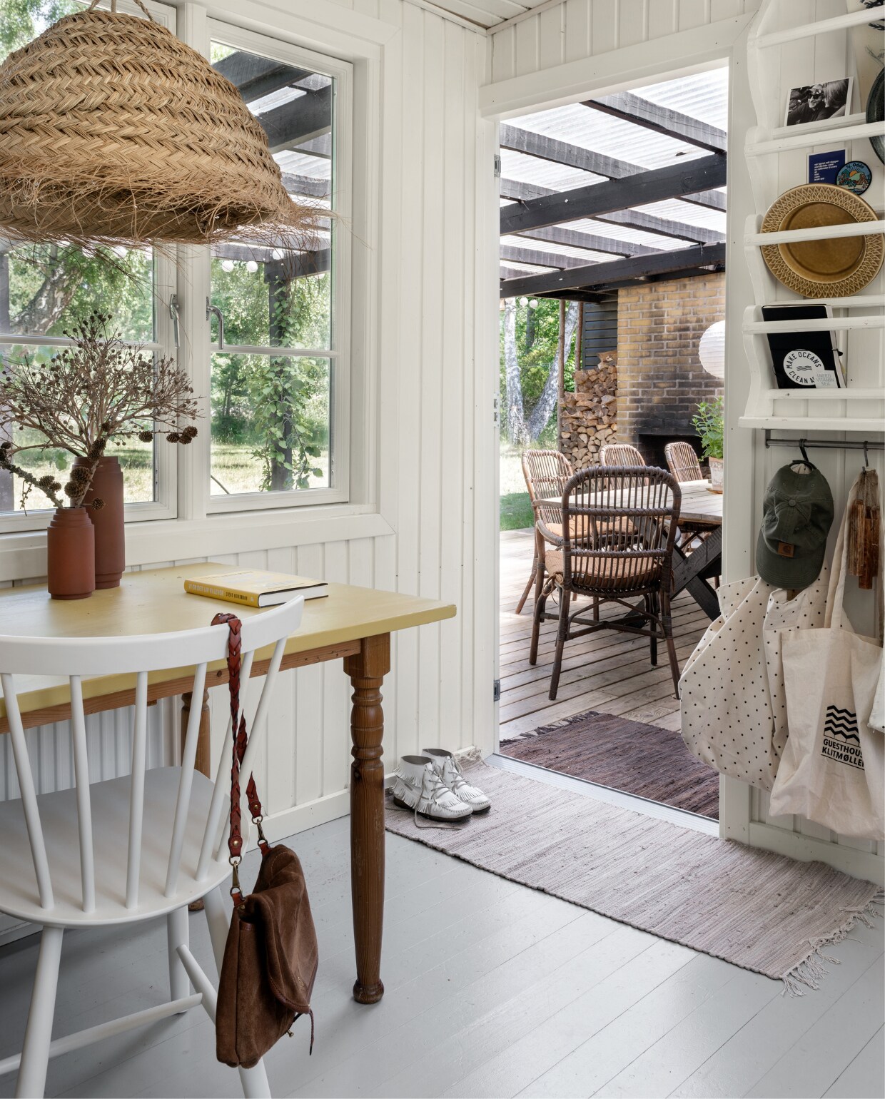 De tafel is nog van Rikke,s ouders geweest, waarvan Rikke het blad geel schilderde. Vaasjes rommelmarkt. Stoelen J46 FDB Møbler. Schoudertas Jerome Dreyfuss. Het witgeverfde bordenrek is zelfgemaakt, met daarin o.a. kaarten, vintage keramiek en tassen en een waterfles van Moshi Moshi Mind. Strolamp Madam Stoltz. Kleden Søstrene Grene. vtwonen Binnenkijker 2022-171 | Productie Living Inside | Fotografie Peter Kragballe | Tekst Sara Dal Zotto | Tekstbewerking Sunna Borghuis