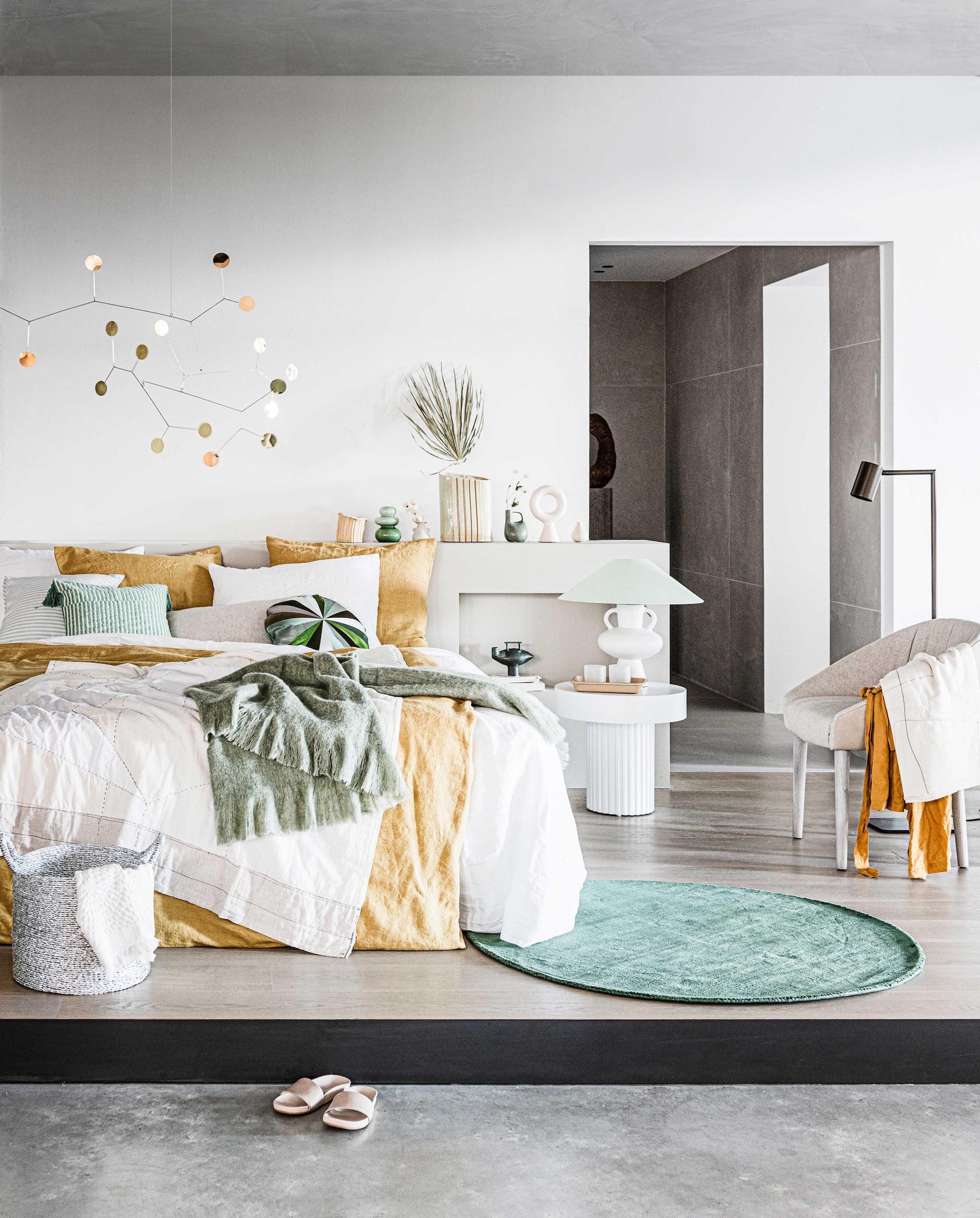 Mobile € 380,- (lpln.de). Geel linnen dekbedovertrek Honey, 140×220 cm € 249,-, wit linnen dekbedovertrek Pure White 140×220 cm € 249,-, linnen kussensloop Honey en Pure White vanaf € 28,- (bymolle.com). Gele vaas boven bed van Floris Wubben, maat M € 180,-, groene vaas met tak erin van Floris Wubben € 395,- (frozenfountain.nl). Groene glazen € 29,95, groen vloerkleed Ø 170 cm € 145,-, mand € 27,95, witte kleine vaas € 16,95 (loods5.nl). Tafel Pillar van HKliving € 249,-, wit ronde ornament Chulucanas van HKliving € 42,95, groene plaid van HKliving 150×125 cm € 64,95 (vtwonen.nl). Witte stenen lampenvoet maat L van HKliving € 119,-, groene lampenkap van HKliving € 79,95 (woononline.nl). Vloerlamp Tribe brons van Piet Boon by Maretti € 448,99, stoffen stoel Cara rechts € 1489,-, twee glazen op nachtkast van Piet Boon by Serax, per stuk € 11,50 (pietboon.com). Wit gestikt plaid op bed € 399,-, leren slippers € 189,-, wit gestikte sjaal over stoel € 179,- (sukha.nl). Lichtgroen met wit gestreept kussen € 22,99, groen met wit gestreept kussen met kwast € 22,99 (zarahome.com). Wit gastendoekje in mand € 5,99, gele linnen badjas € 39,99 (hm.com). Bruin dienblad op nachtkastje, prijs op aanvraag (hayonlinewinkel.com). Overig privébezit. vtwonen 10-2020 | styling Liza Wassenaar | fotografie Sjoerd Eickmans