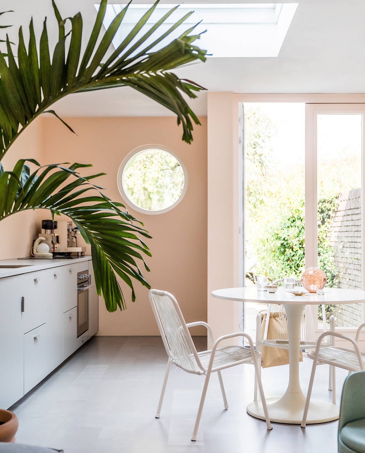 Keuken Ikea. Fruitschaal Fest Amsterdam. Ingelijste foto Marie Bärsch. Eettafel Ikea. Italiaanse ijssalonstoelen Marktplaats, wit geverfd. Betonlook-laminaat Pitch vtwonen. vtwonen special tiny houses 03-2021 | fotografie Muk van Lil | tekst Caroline Westdijk