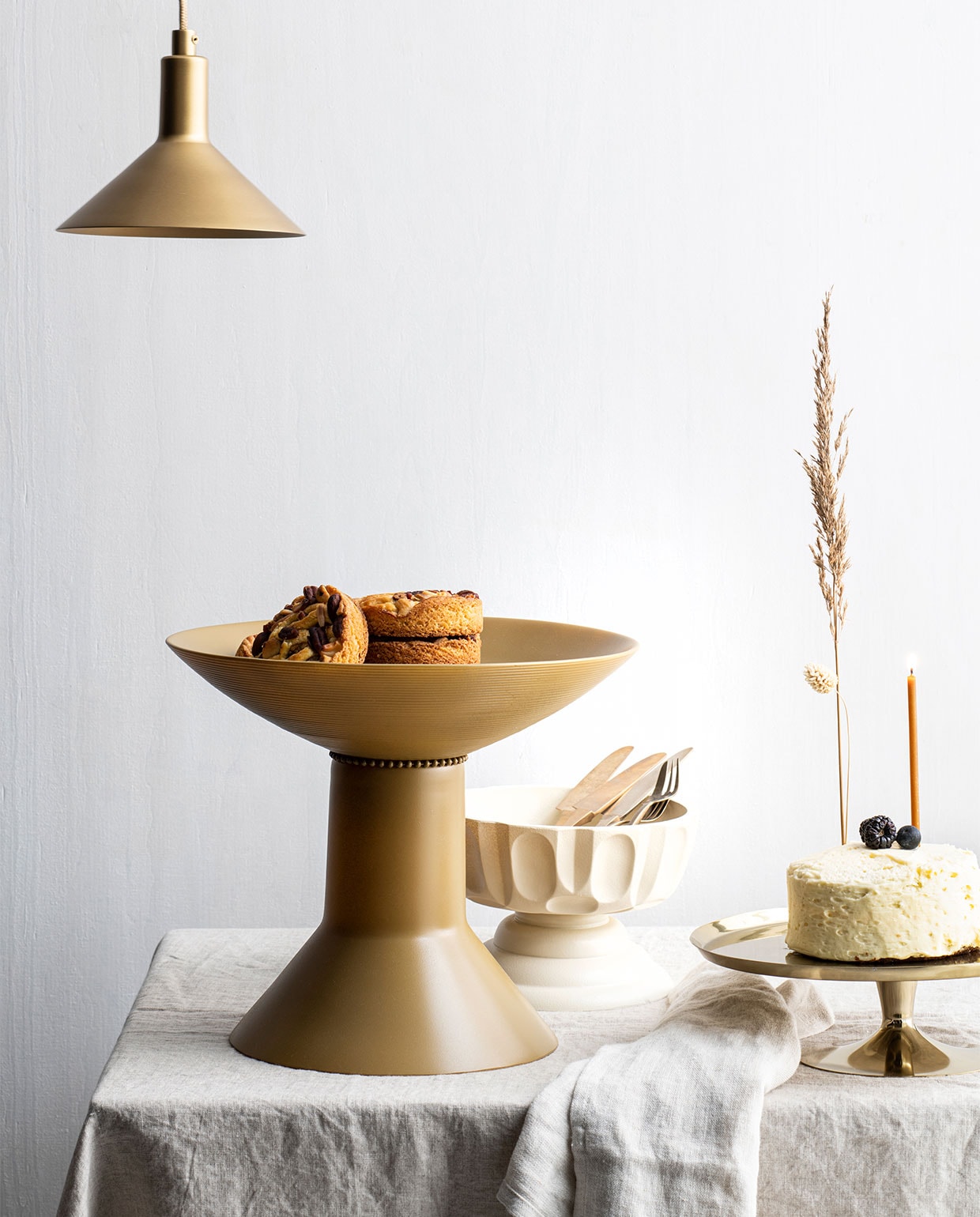 Schaal, ook een diy, maar dan met andere schaal en poot (kringloop). Linnen tafellaken € 49,99, goudkleurig taartplateau € 17,29 (hm.com). Lamp Mathematic S € 49,95 (zaanschfaamwebshop.nl). Kaars op taart Candles of Rituals, per 50 € 15,- (minimuc.com). Linnen theedoek € 12,95 (lichtenfijn.nl). Ribbelglas, per 4 € 35,- (thefinestore.com). Vintage bord (Zaalberg Holland). Overig privébezit. vtwonen 04-2022 | Styling Myla Griese | Fotografie Louis Lemaire