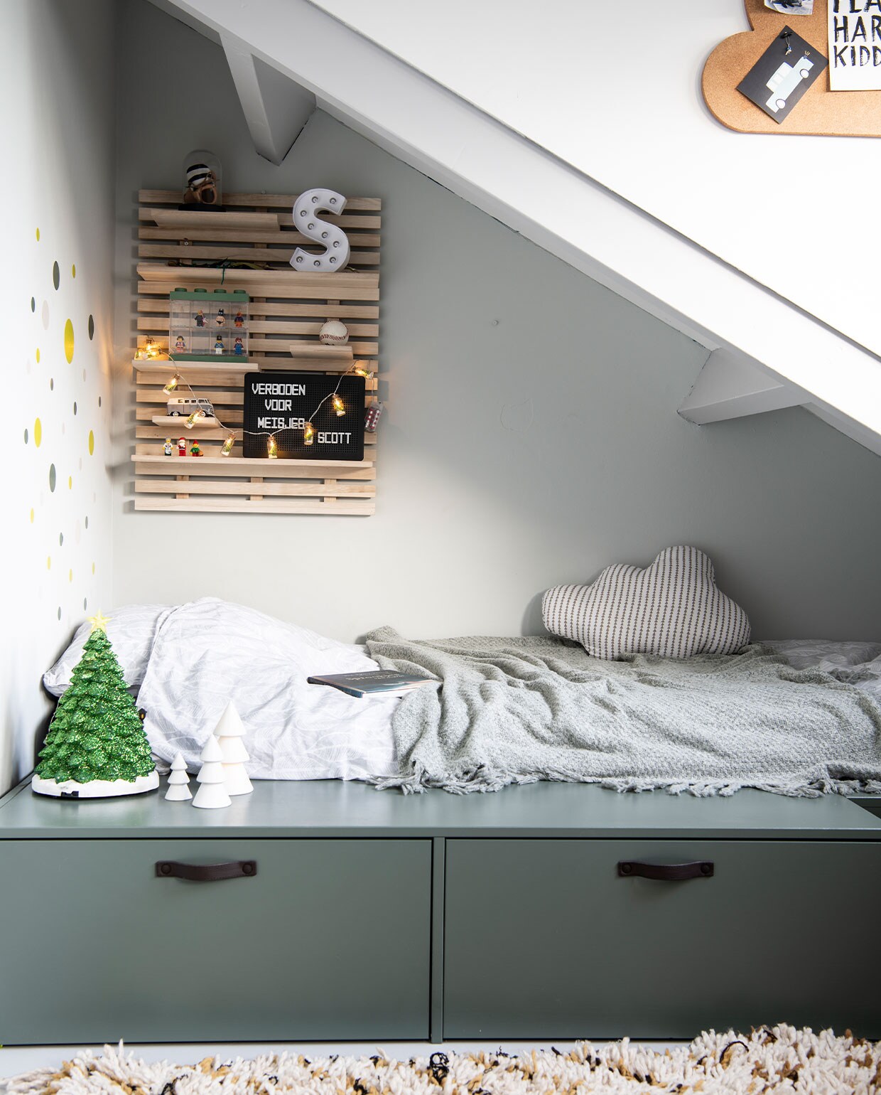 Stage Bed van vtwonen.nl. Dekbedovertrek Witlof for kids. Sprei, witte kerstboom Jysk. Wolk-kussen Made. Wandbord Søstrene Grene. Muurstickers Hema. Groene kerstboom Tuincentrum Osdorp. Kleed Living Maroc. Muurverf Quiet Clearing van Histor. Overig herkomst onbekend. vtwonen 12-2021 | productie Insidehomepage | styling Laura Gommans | fotografie Louis Lemaire