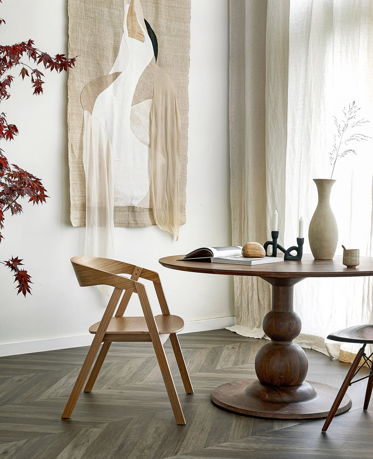 Novilon vloer Zoethout per m² € 29,50. M.m.v. basiclabel.nl (eettafel), demachinekamer.nl (eikenhouten stoel Edske van Sav &amp; Økse, Eames DSW kuipstoel van Herman Miller), studio-yen.com (zwarte kandelaar, houten kei, boek Bea Mombaers), adrianameunie.wordpress.com (artwork met Japanse kraanvogel, in opdracht van Avenue Design Studio). Overig privébezit. JA | vtwonen 07-2021 | styling Marlies Does | fotografie Peggy Janssen | productie Tanja Saarberg