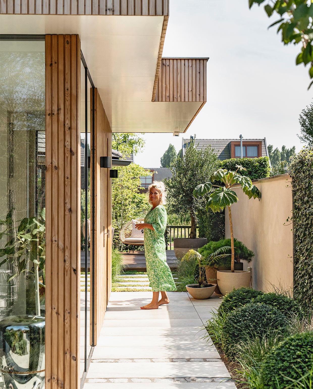 Latten rondom het huis thermopine design rabat. Keramieken buitentegels MBI. Ramen via aannemer. Buitenverlichting In-lite. Bloempotten van Atelier Vierkant via The Garden Store. vtwonen 08-2021 | fotografie Muk van Lil