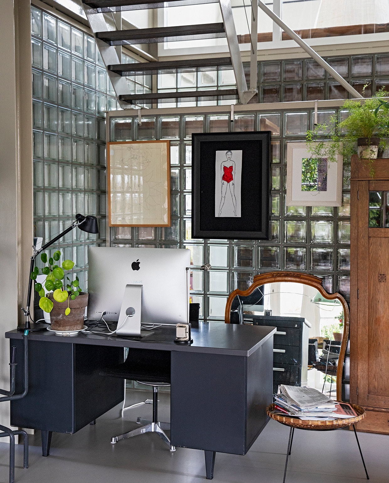 Werkplek van Michiel onder de trap. Oud Gispen-bureau van Karens opa. Leeslamp Artemide. Stoel Vitra. Krantenbak, spiegel en kast vintage. Aan de wand van glazen blokken v.l.n.r.: kunstwerk van Truyen (familiestuk Michiel), tekening van Karen, kunstwerk gekocht in Istanbul.