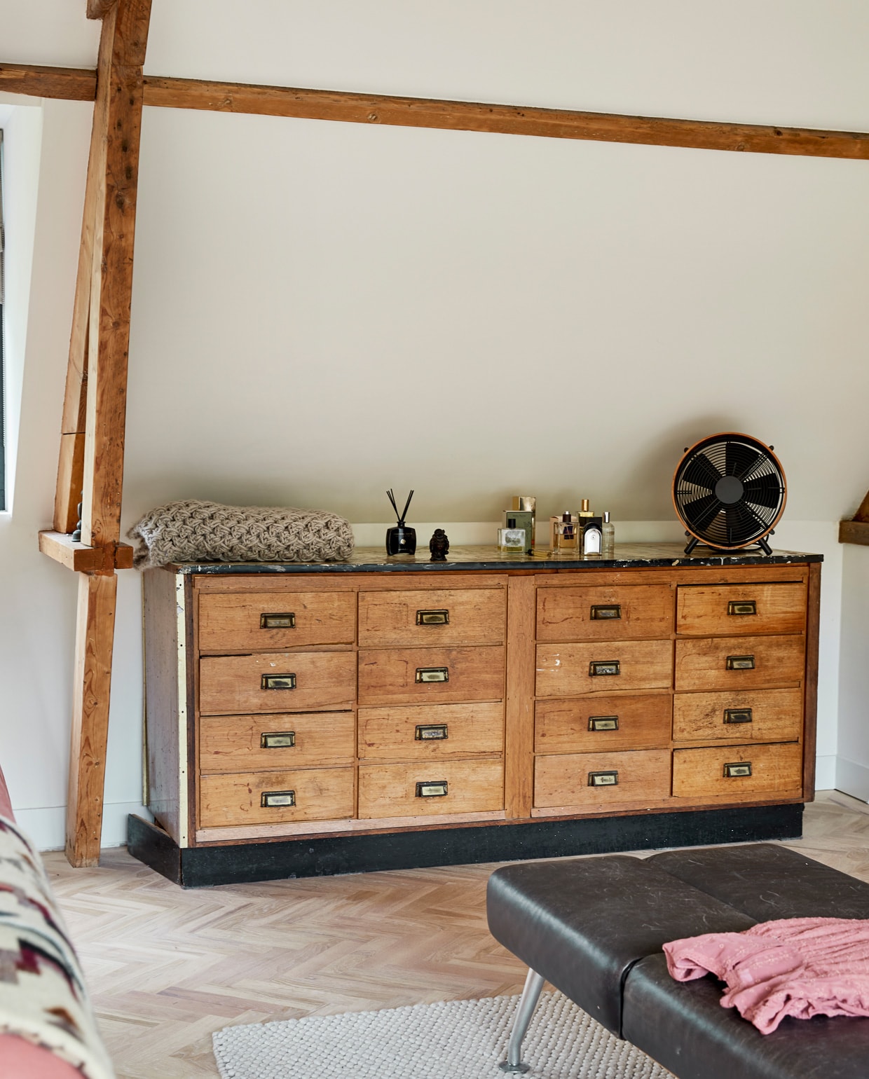Ladekast vintage, ventilator Anno Design, parfum Retreat, sprei zelf gehaakt. Houten vloer Balkan Wood, vloerkleed Hay, bank herkomst onbekend, kleding Zara. vtwonen 05-2021 | fotografie Peggy Janssen | tekst Cathelijne van Wingerden