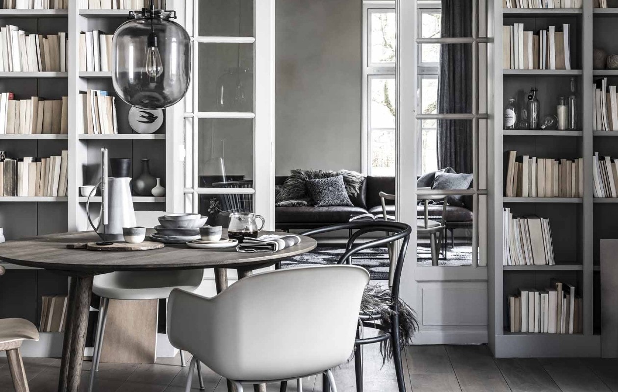 beeld vtwonen Grijs interieur met boekenkast, eettafel en stoelen