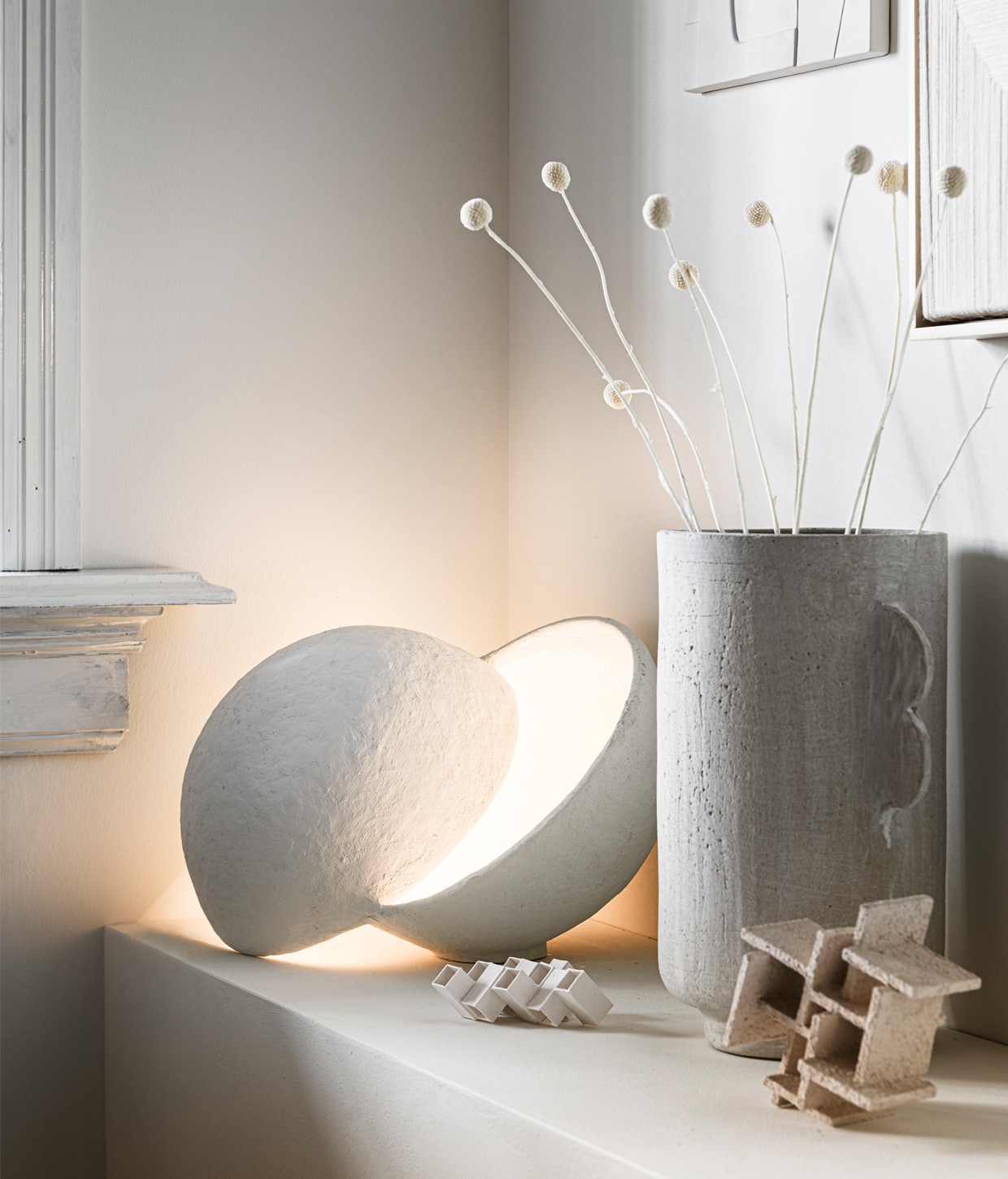 Bolvormige papier-maché lamp van ontwerper Marie Michielssen. Doordat de twee vormen over elkaar vallen, blijft de lichtbron onzichtbaar € 245,- (serax.com). Aardewerken vaas van Urban Nature Culture € 49,99 (sissy-boy.com). Porseleinen kunstwerken Sculpture Maida € 90,-, Sculpture Azi Structured € 150 (studio-yen.com)., , vtwonen 13-2020 | Styling Kim van Rossenberg | Fotografie Sjoerd Eickmans