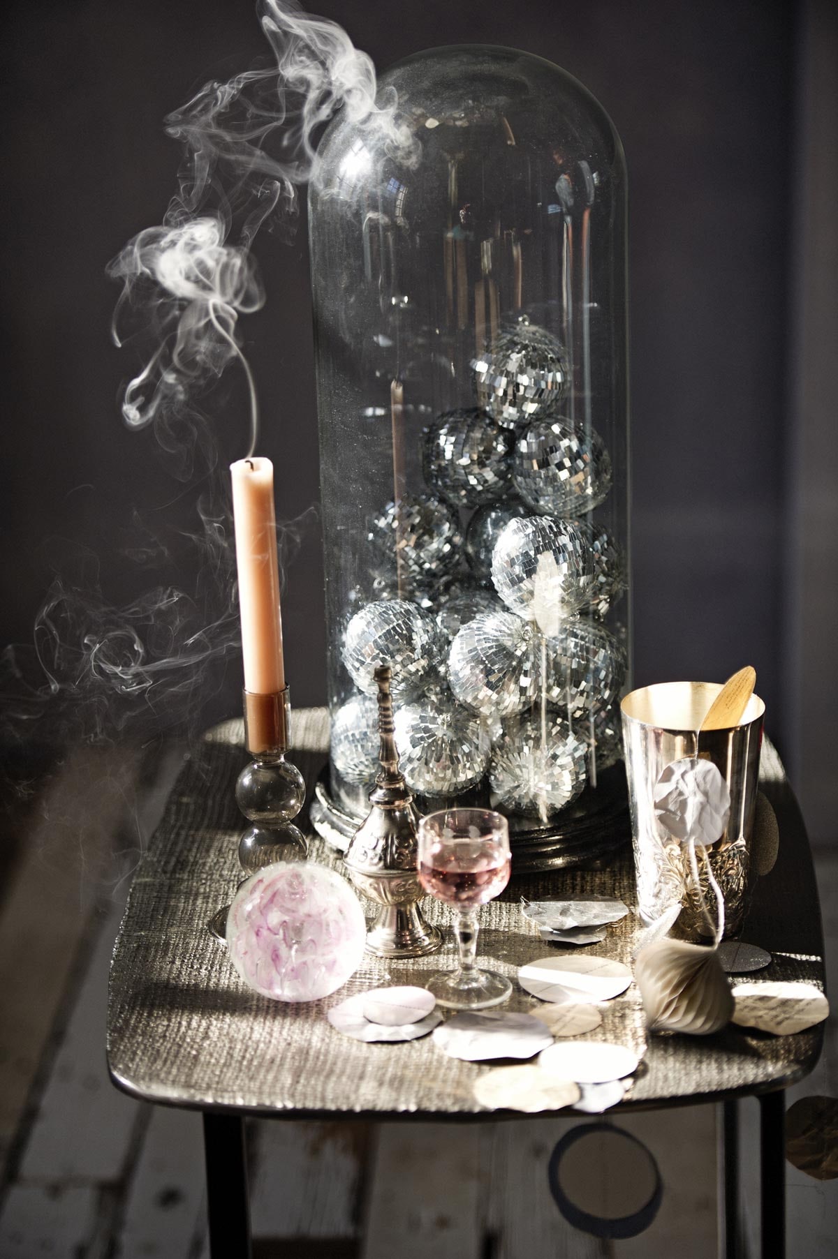 Muurverf licht-blauw kleur Iris van Bauwerk (bauwerk.com.au). Slinger handgemaakt van oud papier, geverfd met verf uit een proefpotje (Carte Colori). Zilverkleurige tafel (Pols Potten). Zilverkleurige beker (Zara). Roze bal (Søstrene Grene). Zilverkleurig sierpotje met smalle bovenkant (Loods 5). Oude stolp (Burbri Antiek). Kaars (Dille &amp; Kamille). Kleine discoballen, kaarsenstandaard van grijs glas met bolvorm (H&amp;M). Glas (kringloop). Limonaderecept van The Holy Kauw Company uit boek Limonade (Uitgeverij Snor).