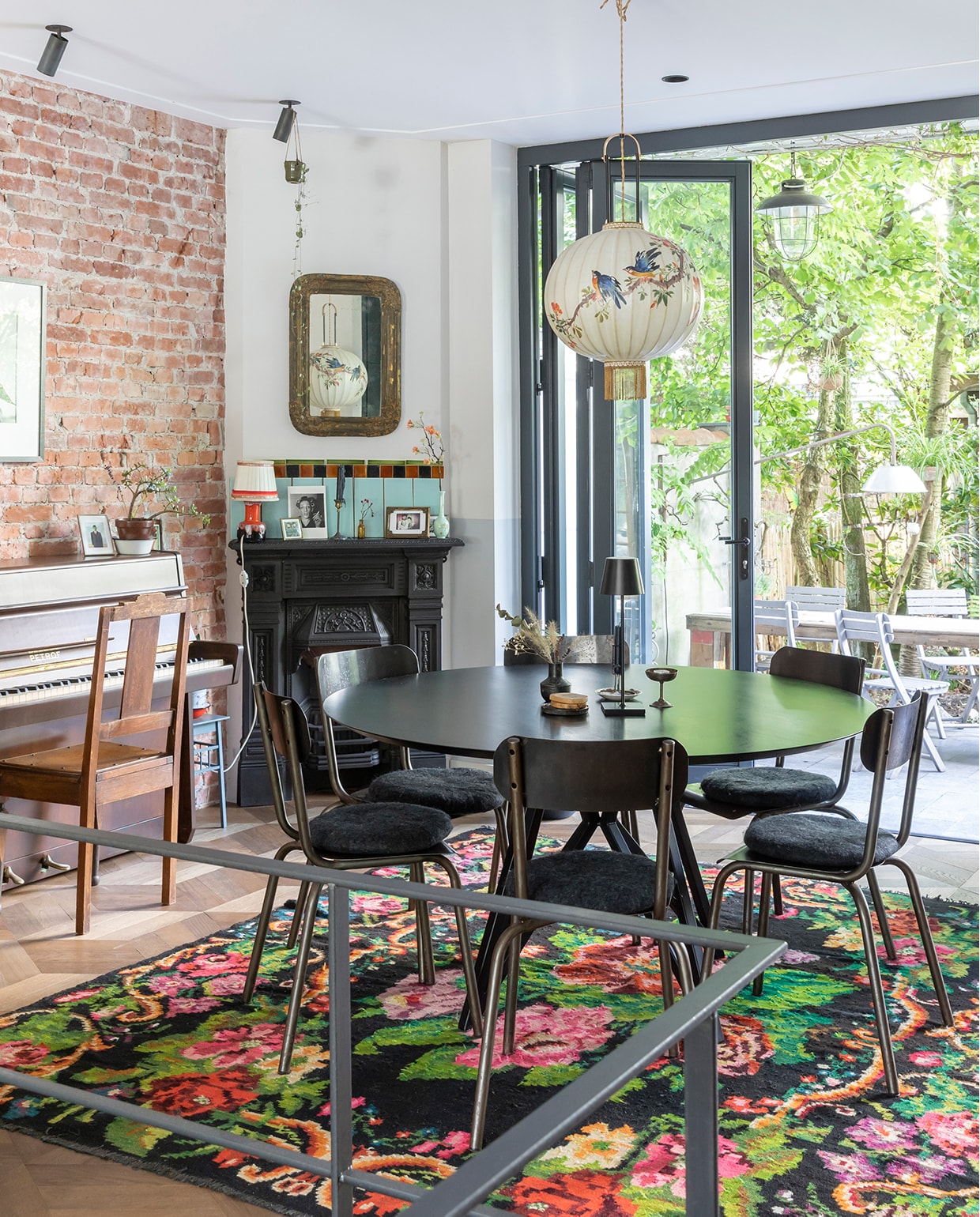 De piano was ooit van Philips oma en werd opgeknapt door Philip en Marieke. Foto erboven van fotografe Ata Kandó, gekocht bij Kahmann Gallery. Tas We Are Vintage. Spiegel boven schouw Marktplaats. Oranje lamp, vaasje en fotolijst rommelmarkt. Schouw Jan van IJken Oude Bouwmaterialen. De vintage tegels erboven komen uit een oud zwembad en werden gekocht bij Mammoet. Tafel Studio Henk. Stoelen uit een winkeltje dat niet meer bestaat. Draadloze lamp op tafel Faro Barcelona. Vaasje Loods 5. IJscoupe van een Franse rommelmarkt. Vloerkleed Rozenkelim. Spotjes Brink Licht. Lamp boven de tafel Taiwan-lantern. vtwonen 04-2020 | Fotografie Margriet Hoekstra