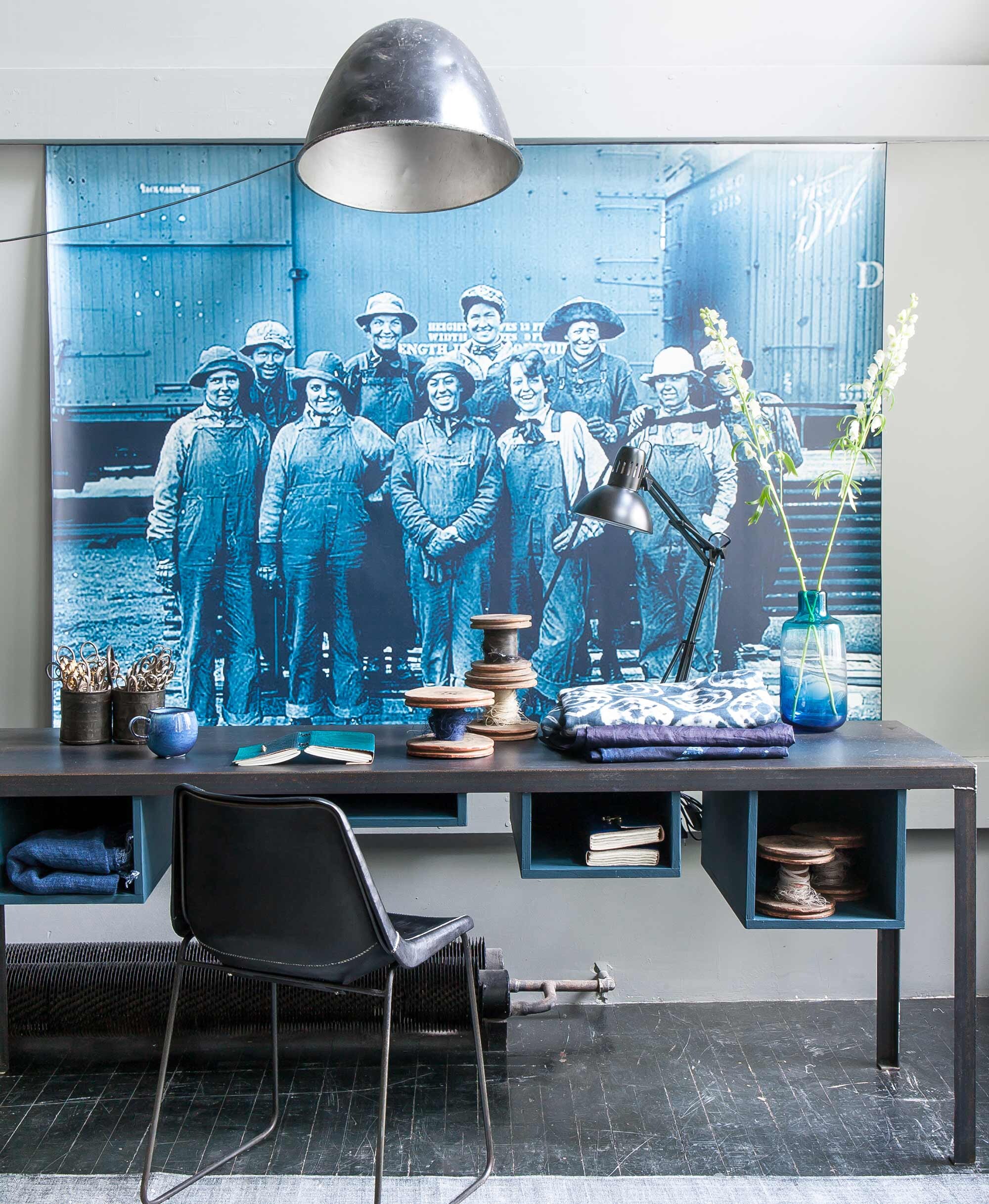 Bureau (). Karpet (). Met leer beklede stoel, industriële muurlamp, klemlamp, leren opschrijfboekjes, klossen, dubbel potje, scharen (). Mok (). Vaas, indigo doeken (). Linnen tie dye doek (). Opgeblazen foto privébezit; soortgelijke kun je laten printen via .