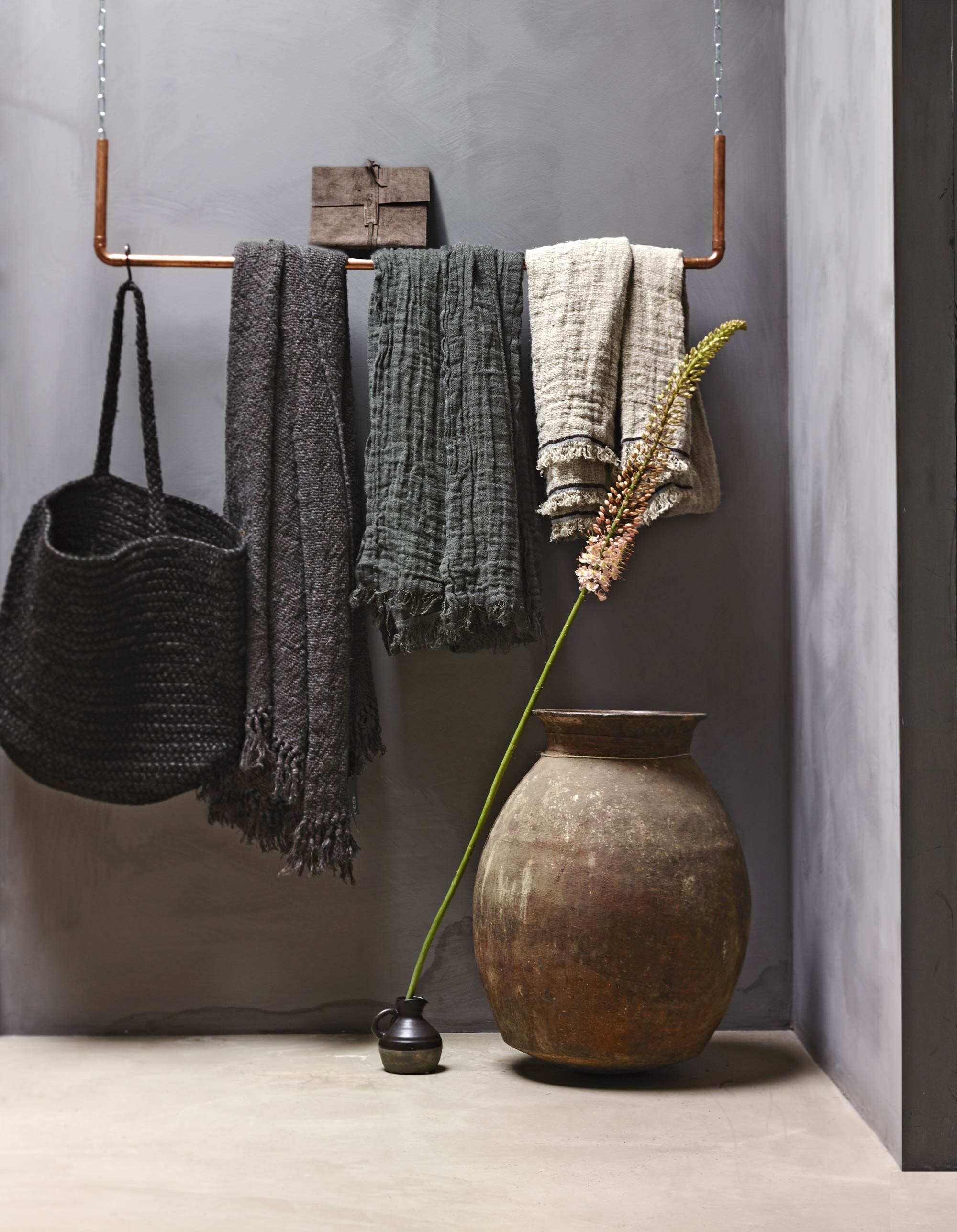 Verf Milkweed uit de Limestone collectie van Bauwerk, gevlochten mand met hengsels, koperen ophang-systeem prijs op aanvraag (AnoukB). Linnen kleden en plaids, schrift met suède cover en aardewerken pot (Hoffz). Kannetje (Nijhof).