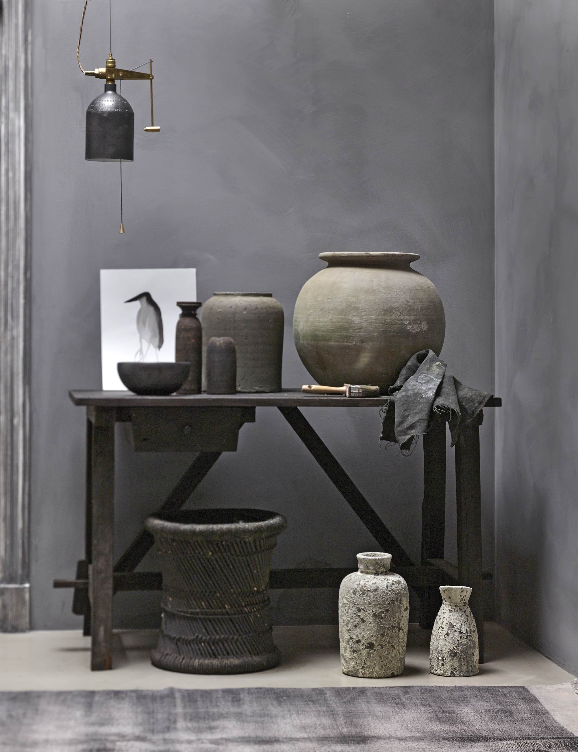 Verf Milkweed uit de Limestone collectie van Bauwerk, bellamp van Wdstck collective (AnoukB). Tafel van zwart geolied hout, cementkleurige stenen kruik maat L, rotan krukje, smalle kruik met hals, houten kruikje zonder hals (Hoffz). Pot, grote witte vaas, kleine witte vaas, zwarte schaal (Nijhof). Inkttekening vogel (Frank Jan van der Laan). Kleed sleets grey (vtwonen.nl). Verflap en kwast privébezit.