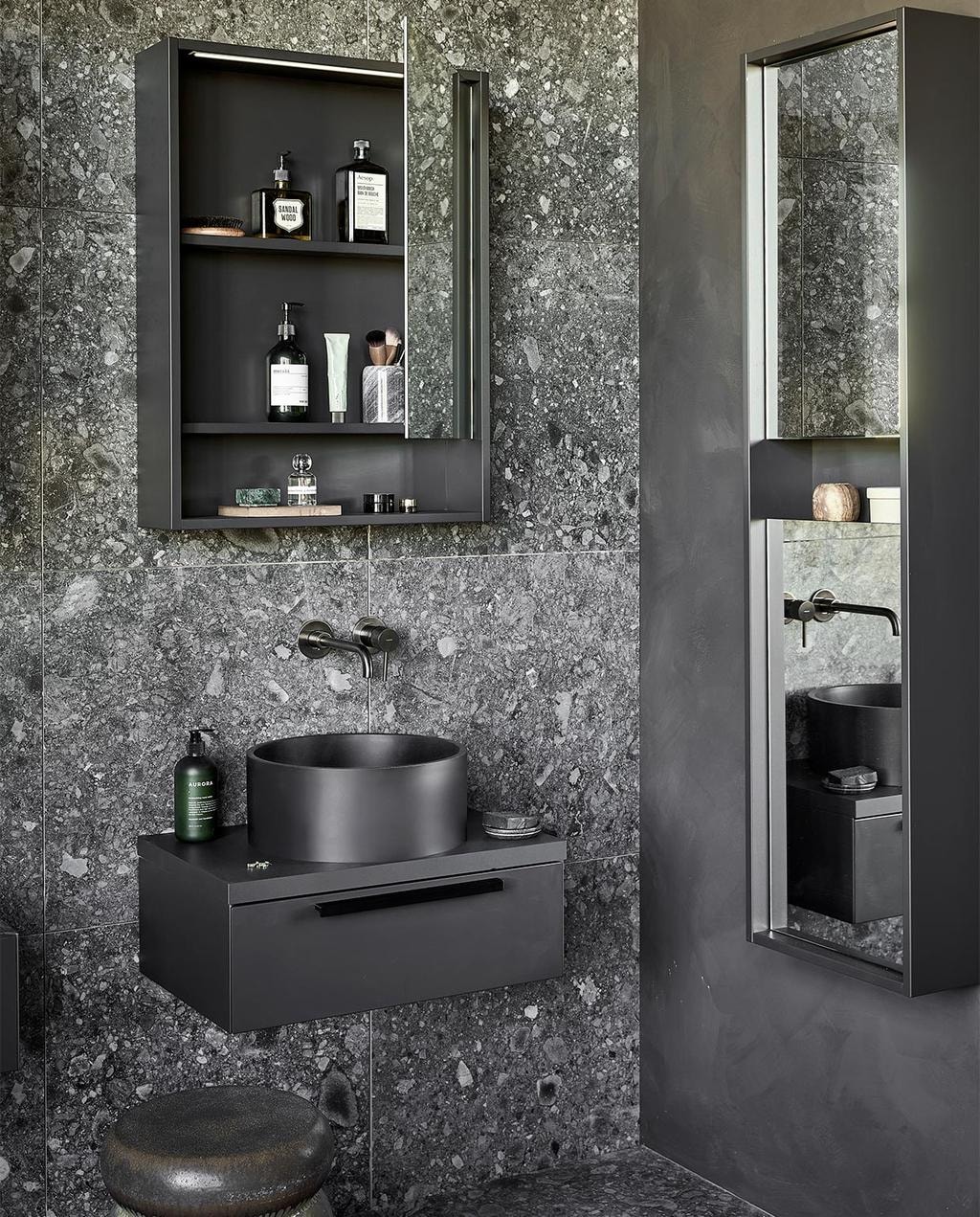 Kunststof spiegelkasten Handy Beauty in zwart, inclusief ledstrip met bewegingssensor, 60x10x80 cm (bxdxh) per stuk € 774,- (ook in breedtematen 90 cm en 120 cm en in wit, zand en grijs). Top solid waskommen Circle in zwart, 37x15 cm (Øxh) per stuk € 488,- (ook in grijs en in Marmer). Kunststof afdekblad in matzwart, 60 cm, per stuk € 145,-. Mat gelakte onderkasten Tidy in matzwart, 1 lade met handgreep, 60x40x20 cm (bxdxh) per stuk € 623,-. Spiegelkolomkast Handy Beauty Long in matzwart met 2 dubbelzijdige spiegeldeuren, 40x16x150 cm (bxdxh) € 762,- (ook in wit, zand en grijs). Top solid bad Endless in zwart, 160x73x57 cm (lxbxh), inhoud 200 liter € 4780,- (ook in grijs en in zand). Op de wand en vloer vtwonen tegels Composite Black Antracite, 60x60 cm, per m² € 65,-. M.m.v. vestingh.nl (kleur op de muur Night Sky No.101), zarahome.com (handdoek, geurkaars in glas), vtwonen.nl (rond juten vloerkleed Eternal van Ferm Living, wandlampen Cast Sconce van Menu, zwart kledingrek Dora van Ferm Living, kruk Bulb van vtwonen), nordal.eu (groen marmeren schaaltje), stories.com (tube crème, oorbellen), wonenmetlef.nl (bruine onderzetter Merge van Ferm Living). Overig privébezit. vtwonen 05-2022 | styling Kim van Rossenberg | fotografie Peggy Janssen | productie Tanja Saarberg