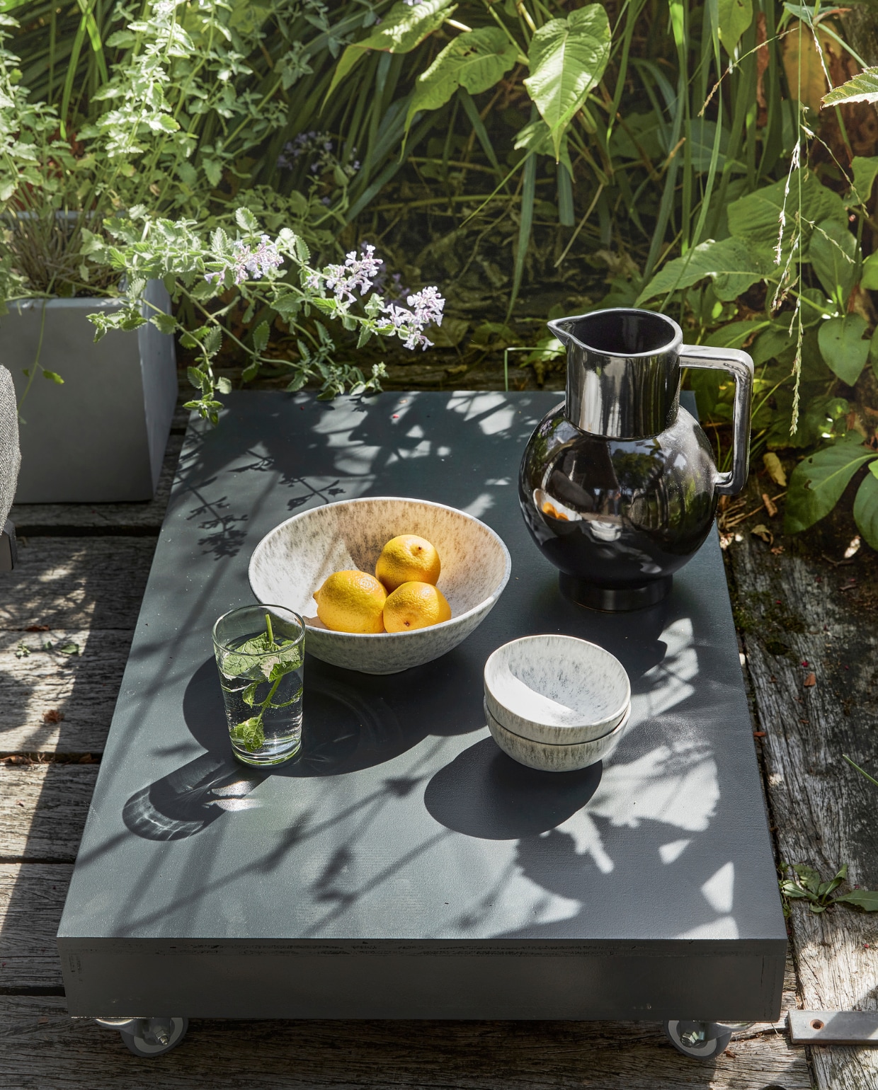Karaf, grote schaal, kleine schalen H&amp;M. Grijze plantenbak Kubus Intratuin. Waterglas privébezit. vtwonen special tuin 07 | productie Corrien Flohil | styling Moniek Visser | uitvoering Johan Snoodijk (@snoodijkenco) | fotografie Peggy Janssen