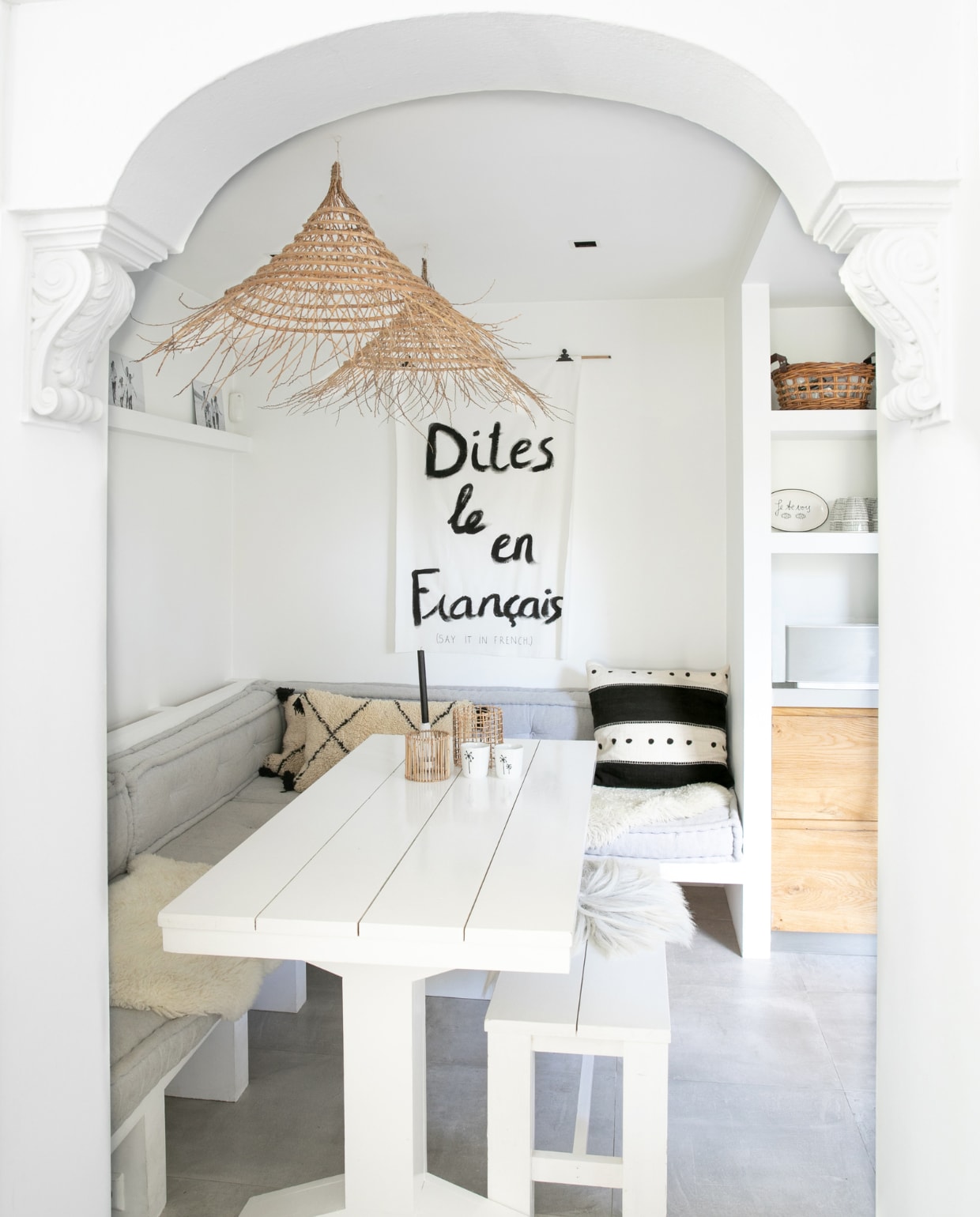 Keukentafel en stucbanken eigen ontwerp, hanglampen Rock the Kasbah, zitkussens op maat Household Hardware, kussens Sukha, vacht Frankes Vachten, wandkleur Ral 9010, microcement vloer. Overig onbekend. vtwonen 04-2023 | fotografie Monique Koelman