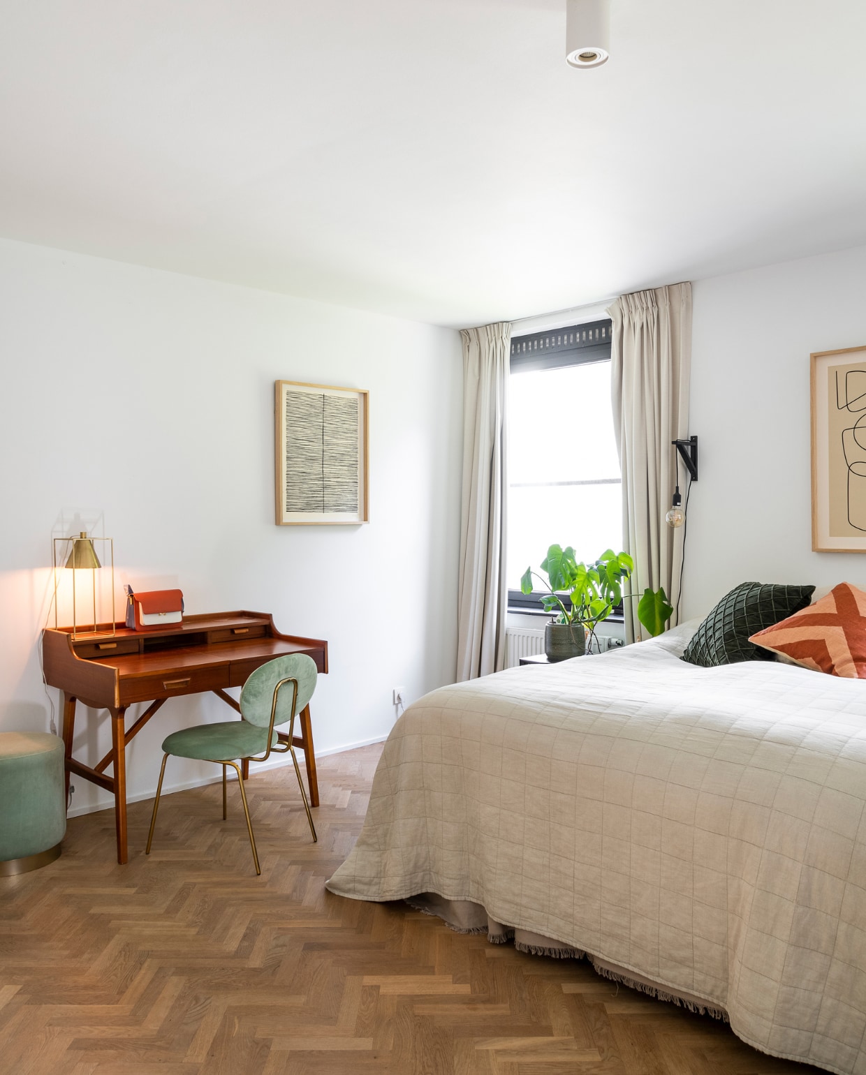 Vloer eiken visgraatparket van Floorhouse. Bureautafel vintage, stoel Hugo, poef Piano en kunstwerk van Furnified, tafellamp HKliving. Bedsprei H&amp;M Home, kussens Chhatwal &amp; Jonsson. Overig onbekend. vtwonen 05-2023 | fotografie Jonah Samyn