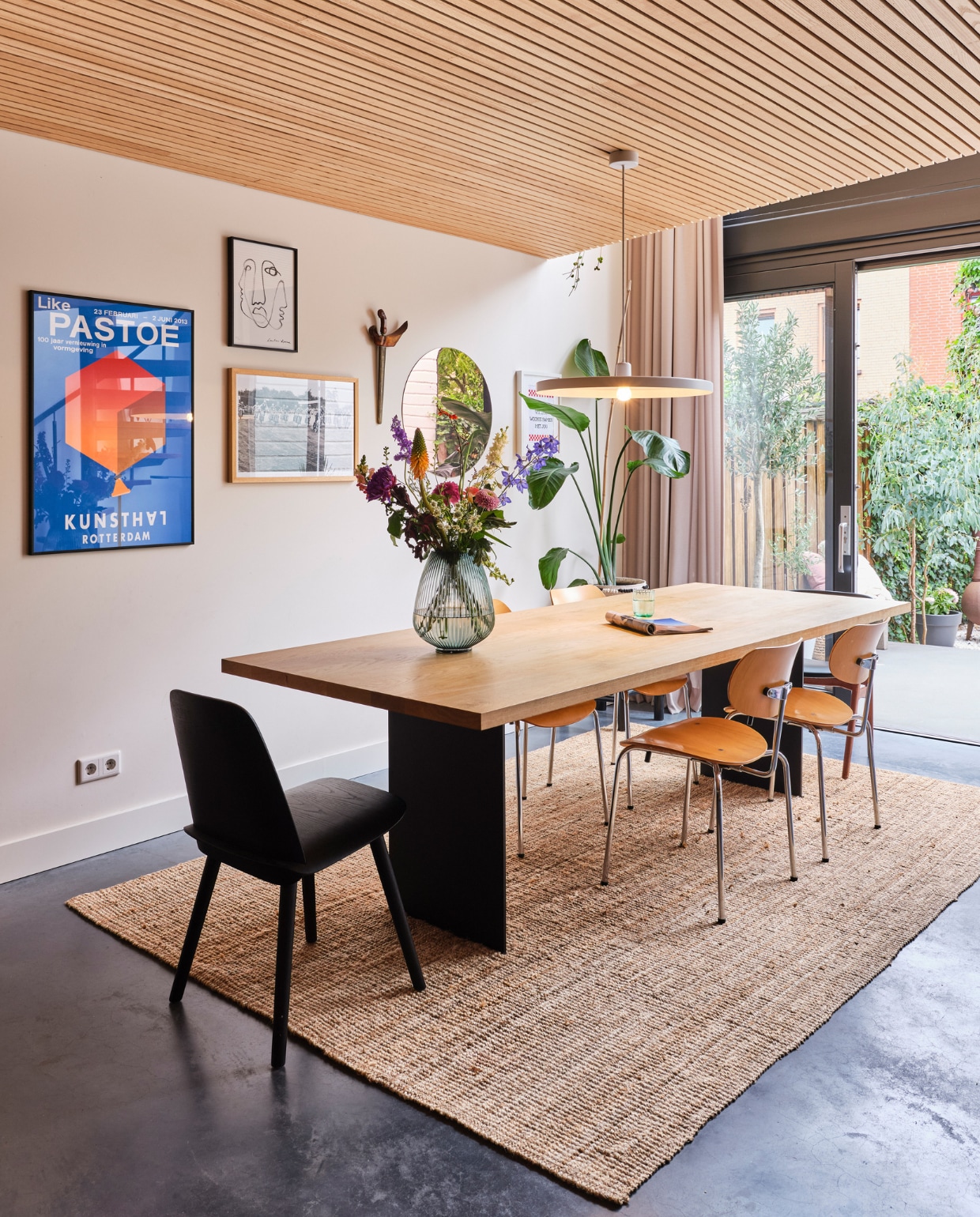 Eettafel Houtmerk. Stoelen Egon Eiermann van Decennia Design. Zwarte stoel Nerd van Muuto. Vaas H&amp;M Home. Hanglamp Tossb. Museumposter Pastoe van Kunsthal. Spiegel Wolfpak Studio. Vloerkleed Ikea. Overig onbekend. vtwonen special binnenkijken 03-2023 | fotografie Rene van der Hulst