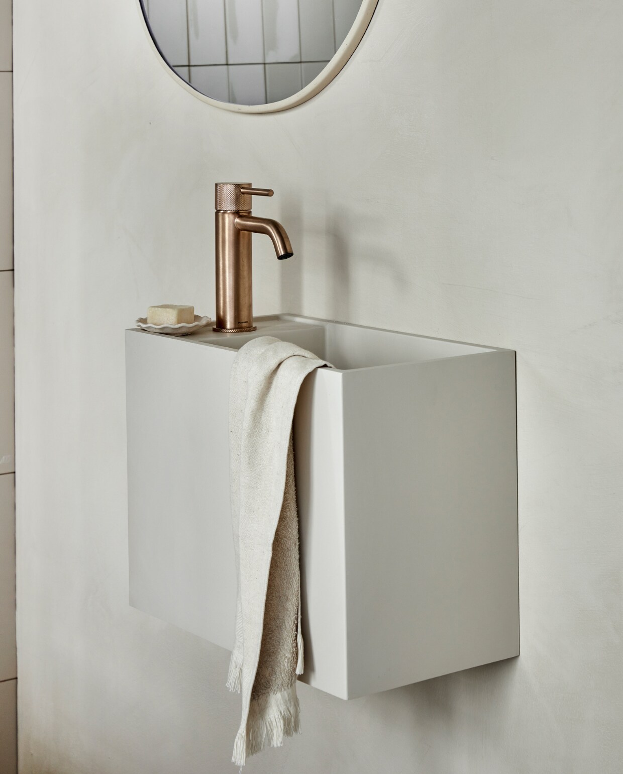 Top solid toiletwastafel Wide in zand, 40x30x22 cm (bxdxh), ook in grijs, wit en zand, in marmer in wit, bruin, zwart en zilvergrijs. M.m.v. plieger.nl (wastafelkraan Roma), zarahome.com (handdoek, zeepschaaltje, spiegel). Overig privébezit. vtwonen 05-2023 | productie Tanja Saarberg | styling Sanne Ketelaar | fotografie Peggy Janssen