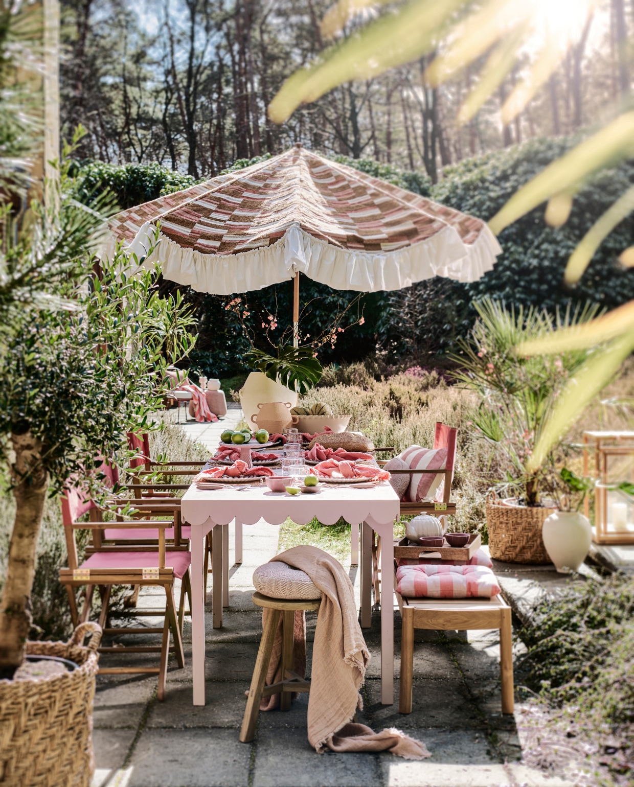 Tweedehands parasol prijs op aanvraag (com-anders.nl), met nieuwe stof Missori LR-347-21 van Elitis prijs op aanvraag (loggerewilpower.com). Tafel op maat gemaakt, prijs op aanvraag (com-anders.nl), met roze tegels Zellige Gris Rose Poisson Echelles, 10x10 cm, per m² € 179,50 (designtegels.nl). Houten kruk € 69,99, rieten placemats, per stuk € 9,99, glazen borden, per stuk € 6,99, kleine witte vaas € 39,99, manden per stuk € 89,99, witte vaas op de grond € 69,99, gestreepte kussens, per stuk € 17,99 (zarahome.com). Duurzaam teakhouten lantaarn € 499,-, duurzaam teakhouten bank € 2000,-, roze poef € 1110,-, parasolvoet € 109,-, ronde kussens 30 cm (Ø) € 150,-, (dacks.nl). Terra stalen stoel € 525,- (extravert.nl). Waterglazen, per stuk € 7,99, roze servetten, set van 2 € 12,99, onderste borden, per stuk € 9,99, roze schaaltjes, per stuk € 4,99, theepot € 29,99, houten dienblad € 39,99, roze doek op stoel op achtergrond € 22,99, roze-wit gestreepte vaas links op achtergrond € 19,99 (hm.com). Bestek Ottolenghi Feast van Serax, 24-delig € 137,-, stoelen Dalisa van Kave Home, duurzaam acaciahout en polyester, 55x43x88 cm (bxdxh), per stuk € 106,- (vtwonen.nl/shop). Planten prijs op aanvraag (plantje.nl). Grote schaal € 59,99, lichtroze plateau € 39,99 (sissy-boy.com). Roze plaid op voorgrond van Maison de Vacances € 210,-, houten dienblad van Serax € 99,- (couleurlocale.eu). Houten bakje vooraan op tafel € 12,95, witte vaas met oren Sava € 169,- (urbannatureculture.com). vtwonen 06-2023 | styling Liza Wassenaar | fotografie Sjoerd Eickmans