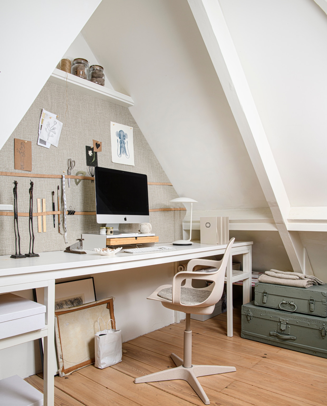 Bureau gemaakt van een oude tafel (kringloop). Wit beige bureaustoel Odger € 67,96 (ikea.com). Stoelkussen vilt rond € 11,98 (sostrenegrene.com/nl). Op board: beukenhouten liniaal, 30 cm € 3,95, rvs schaar € 12,95 (dille-kamille.nl). Halfronde cirkel mal € 2,10 (sostrenegrene.com/nl). Kwasten en meetlint, clip en tekeningen (privébezit).Op bureaublad: beeldjes gietijzer, verfpotjes (privébezit). Vintage nietmachine (kringloop). Schaaltje koraal € 8,40 (sostrenegrene.com/nl). Desktopmonitor Mac (apple.com). Witte monitorstandaard Elloven met lade, 47x26x10 cm € 24,99 (ikea.com). Wit ijzeren bureaulamp Pixie, 25x30x39 € 99,- (zuiver.com). Ringband met wit etiket € 12,95 (dille-kamile.nl).Op bovenste plank: jute touw (privébezit). Helder glazen voorraad met beugelsluiting € 5,60, klossen katoen Oeko-tex bruin € 2,38 (sostrenegrene.com/nl).Onder bureau: diverse canvassen, ingelijste kunst (privébezit). Witte opbergdozen Tjena met deksel, 25x35x10 cm € 3,49 (ikea.com). In hoek: geschilderde vintagekoffers prijs op aanvraag (com-anders.nl). vtwonen 09-2023 | Styling Marit Saladini | Fotografie Louis Lemaire | Assistentie Rosa van Schie, Kiki de Koning