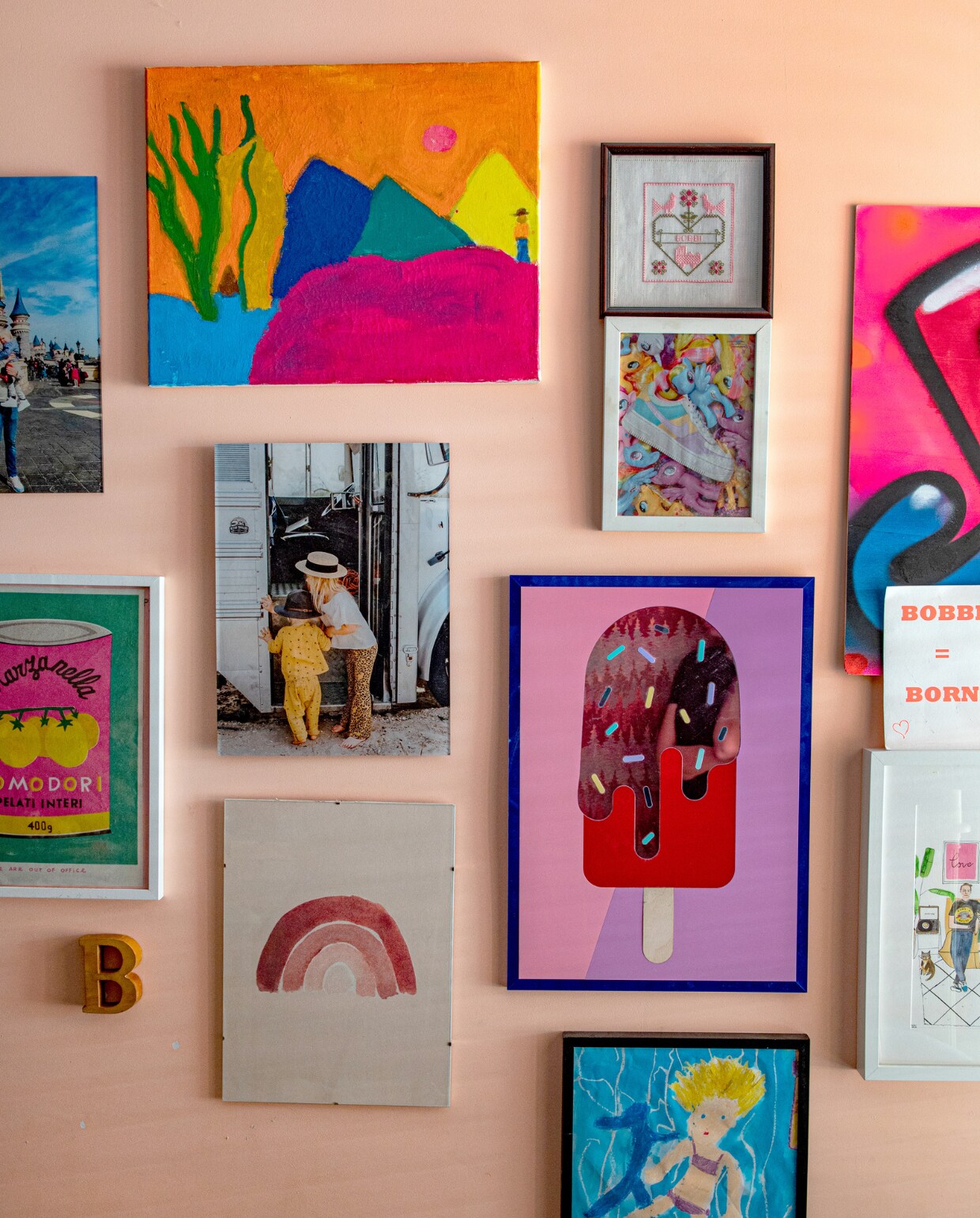 Verzameling met voornamelijk kunstwerken van de kinderen en familiefoto’s, muurverf in Formosa van IJm Colour. vtwonen 07-2023 | productie De Binnenkijkers | styling Jeske Weel | fotografie Caroline Coehorst