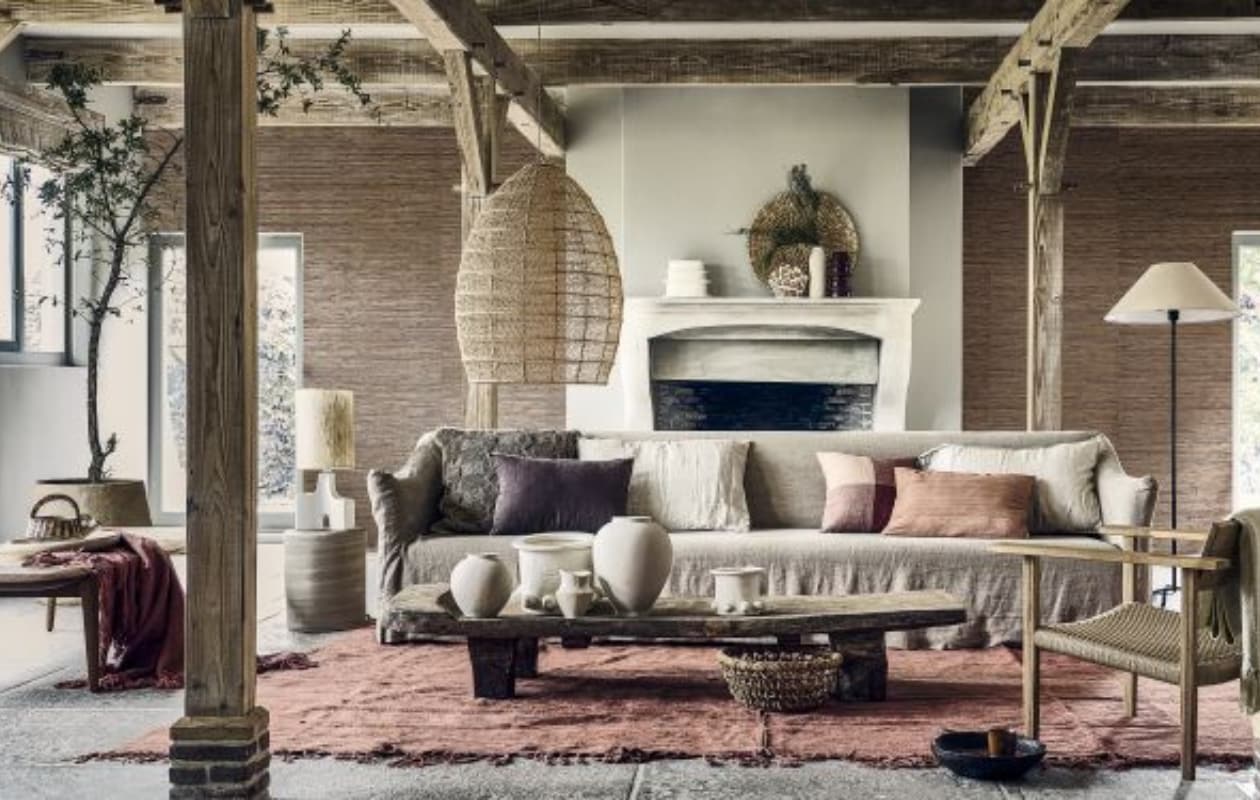 Papieren behang Natural Wallcoverings 3 in 303549, 550x91 cm (lxb), per rol € 160,- (eijffinger.com). 3-Zitsbank Coen, 220x95x80 cm (bxdxh) € 3999,- (lauthentique.nl). Ligbed Tangāli van Phantom Hands, teakhout en natuurlijk riet, 190x74,5x41 cm (lxbxh) € 3380,- (hetarsenaal.nl). Handgemaakte eiken loungestoel, 76,5x64,5x64 cm (lxbxh) € 899,-, schaal op ligbed prijs op aanvraag (sukha.nl). Lamp met driepoot, metaal en katoen, 41x155 cm (Øxh) € 179,-, grijze vaas, set van 2 vanaf € 39,99, ecru ongelijkvormige vaas van aluminium, set van 2 vanaf € 22,99, gebroken witte vaas met textuur, set van 2 vanaf € 17,99, ronde mand van banenblad € 39,99, bruine jute kussenhoes € 49,99, ecru linnen kussenhoezen € 15,99, oudroze linnen kussenhoes met ruit € 22,99, paarse kussenhoes € 29,99 (zarahome.com). Katoenen plaids van Malagoon in Timber Terracotta en Clay White, 152x127 cm, per stuk € 39,95, papier-maché bloempot Construct van Serax € 469,-, beige stenen bijzettafel Pawns van Serax, 32x39 cm (Øxh) € 349,-, beige aardewerken vazen Molly van Serax, pot 05 maat M € 90,-, pot 05 maat L € 245,-, pot 06 maat M € 65,-, okerkleurige keramische kop Merci nº9 van Serax € 10,-, geglazuurd keramieken bord Terres de Rêves van Serax € 26,99 (vtwonen.nl/shop). Mangohouten schaal Modern Rustic € 79,-, tafellamp Hikari, steen en zijde, 55x22,5 cm (Øxh) € 189,-, decoratief ecomix object Calcolo, set van 2 € 84,95, handgeweven zijden kussen Almond € 72,95 (urbannatureculture.com). Houten tafel Naga, 188x52x28 cm (lxbxh) € 2995,-, rood hennep vintage tapijt uit Turkije, 225x177 cm vanaf € 990,-, macramé hanglamp, raffia met metalen structuur, 50x70 cm (Øxh) € 395,-, bruine keramische vaas Terre de Sienna € 59,-, rode aardewerken lepel Merci L € 15,-, wandschaal Porcupine, ilala palm € 149,- (couleurlocale.eu). Vaas en kan (kringloopcentrumbollenstreek.nl). Overig privébezit. vtwonen 2023-09 | Styling Liza Wassenaar, assistentie Lila Steijger, Judith Koers, Kula Isabelle Den Broek | Fotografie Sjoerd Eickmans
