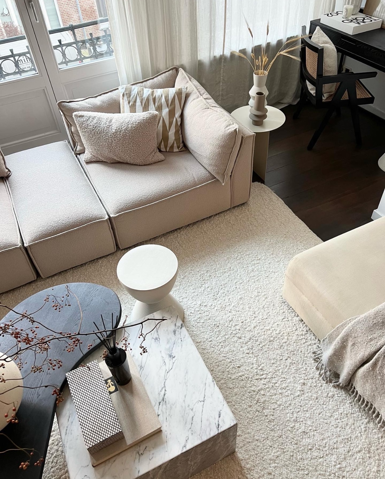 Modulebank Daphne en vloerkleed van Sofacompany. Salontafels maatwerk van Onno Design. Kruk van Philip Starck, zelf geschilderd. Bijzettafel Coco Maison. Hoge vaas HKliving. Lage vaas Bloomingville. Stoel Lumz. Vaas op salontafel Urban Nature Culture. Overig onbekend. Klaas Hogeweg