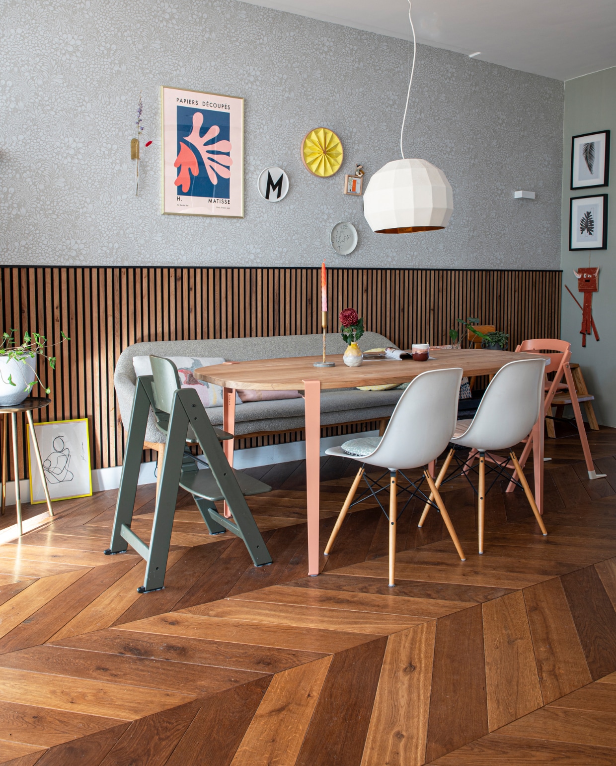 Eettafel DIY-blad met poten van Tiptoe, mok Prchtg, kandelaar Morph Design, stoelen Vitra, groene kinderstoel Kidsmill, roze kinderstoel Kaos, eetkamerbank Bolia, kussens Tom Dixon, hanglamp Marset, lambrisering Woodupp, bijzettafel Nijhof, behang Midbec, bord met letter M Design Letters, tegel Storytiles, gele klok Snowpuppe, poster Matisse van Postery, wandlamp Wever &amp; Ducré. Houten vloer Van der Heijden vloeren. Overig onbekend. vtwonen special DIY 7 | fotografie Caroline Coehorst