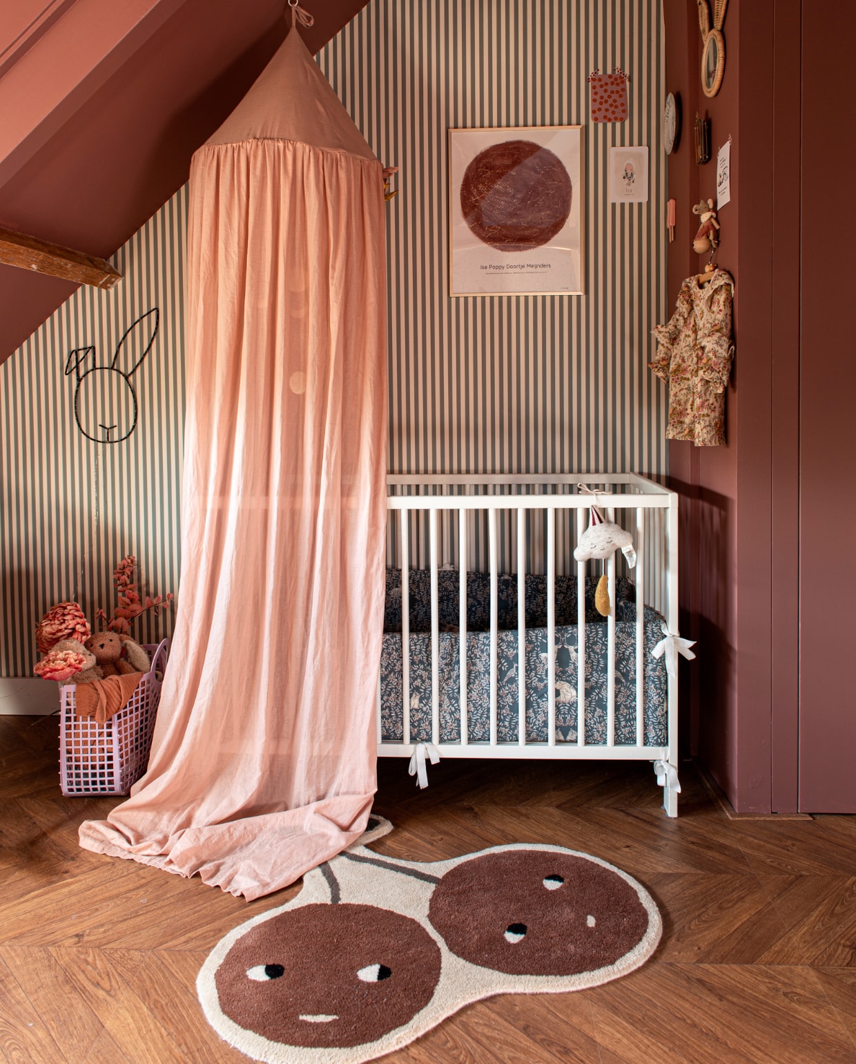 Behang Ferm Living, ledikant Ikea, hemel en mand Liewood.  Konijnlamp Vraĉo, poster MrStarsky, bedbumper Garbo &amp; Friends, vloerkleed Oyoy, muziekwolk Konges Sløjd, ijsje Prchtg, spiegel Wonder for Kids, muis Maileg, jurk Louise Misha, verf houtwerk en muur Ashes of Roses van Little Greene. Overig onbekend. vtwonen special DIY 7 | fotografie Caroline Coehorst