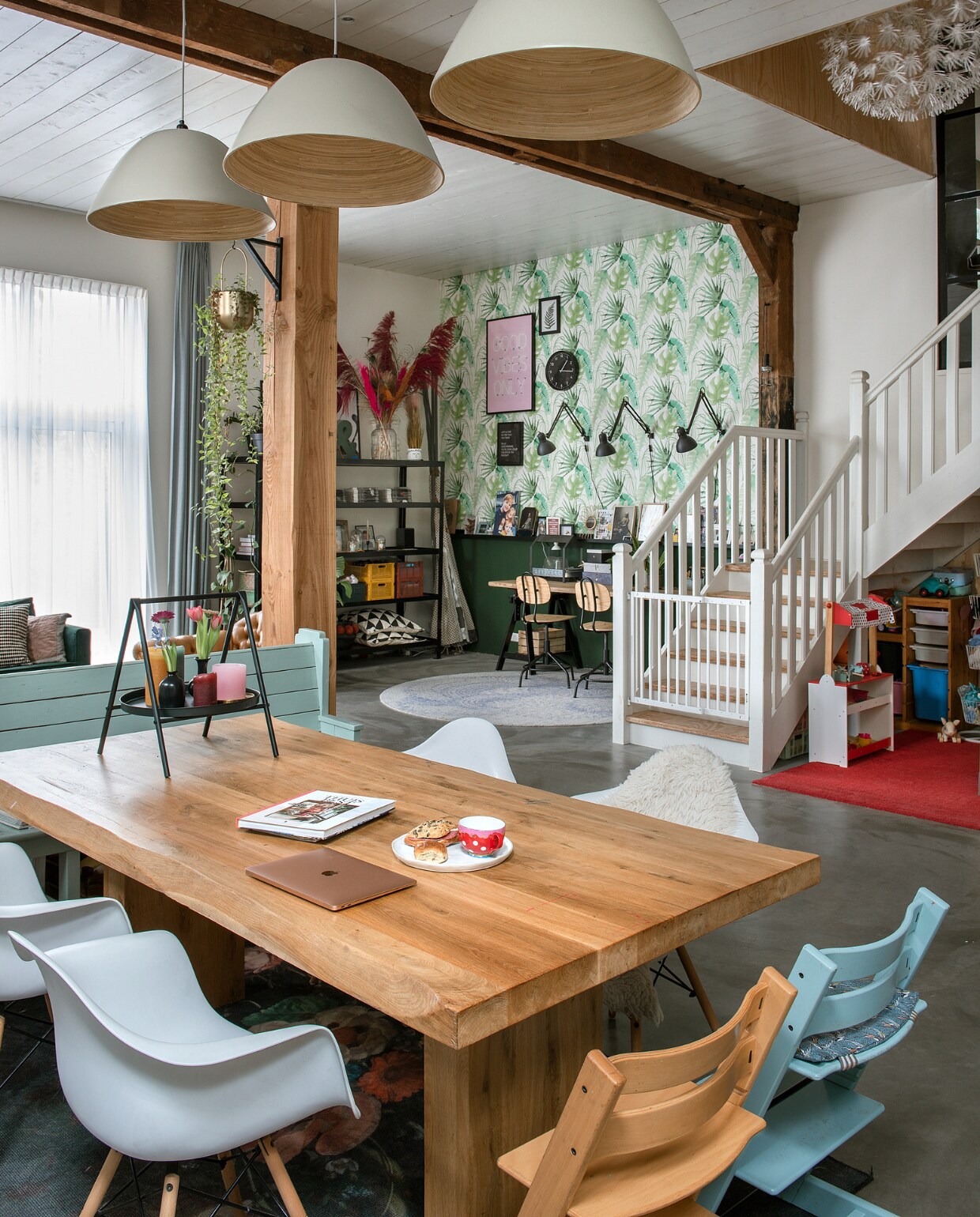 Tafel Koperen Bel, stoelen Furnpact (levert niet meer), kinderstoelen TripTrap van Stokke, kerkbank Marktplaats, rekje op tafel Kwantum. Gele bank Wehkamp. Gebloemd vloerkleed Kwantum, gestreept vloerkleed Ikea. Lage kast zelfgemaakt. Lampenkappen Xenos, snoeren Snoerboer, industriële lamp Het Erfgoed. Keuken Koak Design. Betonnen houtkachel Jacobus via Woodflame. Grijze wandtegels vtwonen, witte wandtegels Praxis. Vloer Woonbeton. vtwonen special DIY 6-2022 | fotografie Ton Bouwer