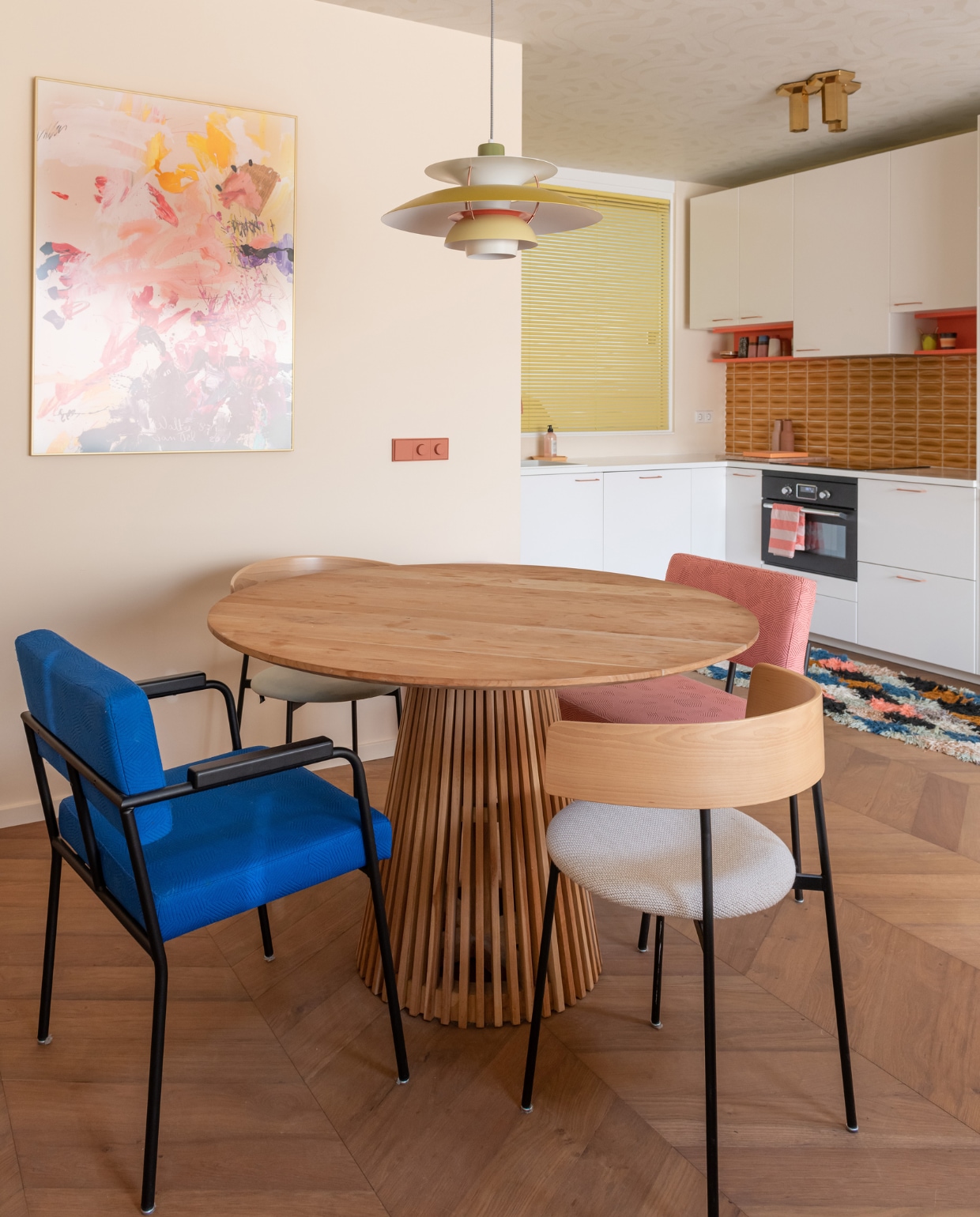 Muurverf Red Terra van Flexa Pure. Eettafel Kave Home, stoelen Fést. Hanglamp Louis Poulsen, schilderij Walter van Oel, lichtschakelaars Yung. vtwonen special binnenkijken 12-2023 | fotografie Caroline martinot