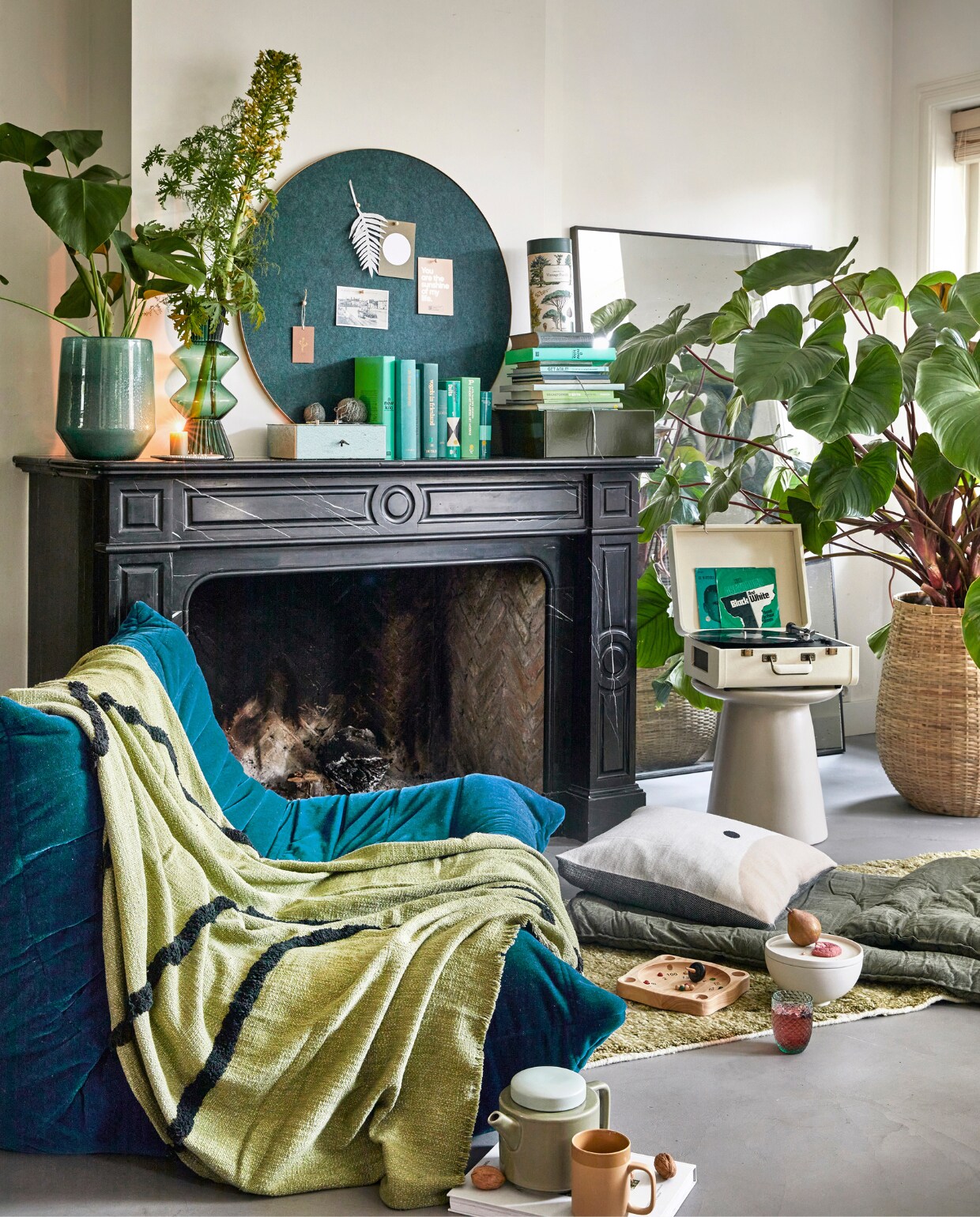 Tweedehands zitelement (whoppah.com). Pistachegroene plaid van HKliving, 170x130 cm, groene glazen vaas Davine van Bloomingville, aardewerken bijzettafel Earthenware van HKliving, 43x40 cm (vtwonen.nl). Donkergroen katoenen matraskussen, 190x70 cm, kaarten op prikbord, bord onder kaars, groene kaars (pluumwinkel.nl). Crèmekleurig alpacawollen kussen van Form &amp; Refine, 52x52 cm, witte keramieken kom met deksel Setomono van Kristina Dam, rond groen-messing prikbord Retell van Gejst Design, 80 cm (Ø) (byjensen.nl). Groen glas Harlequin van Anna von Lipa, vintage puzzel Cavallini Papers &amp; Co, 1000 stukjes (eduard-leiden.nl). Olijfgroen-paars wollen handgeknoopt vloerkleed HKliving, 80x300 cm, platenspeler Portfolio van Crosley, 41,5x44x20,5 cm, olijfgroene kartonnen opbergdoos van Hay, 35x29,5x12,5 cm, houten prikbordpinnen van Oyoy, per 25 (wonenmetlef.nl). Theepot Kinta XL, okerkleurige theemok Kinta L (vanmanenaantafel.nl). Philodendron, glazen plantenpot van Dutz, bamboe mand met plant, bloemen (stadstuindebloemenpoort.nl). Roulettespel van Egmont Toys (ilovespeelgoed.nl). Geldkist, spiegel, boeken en bolletjes katoen privébezit. vtwonen 02-2023 | styling Femke Pastijn | fotografie Peggy Janssen