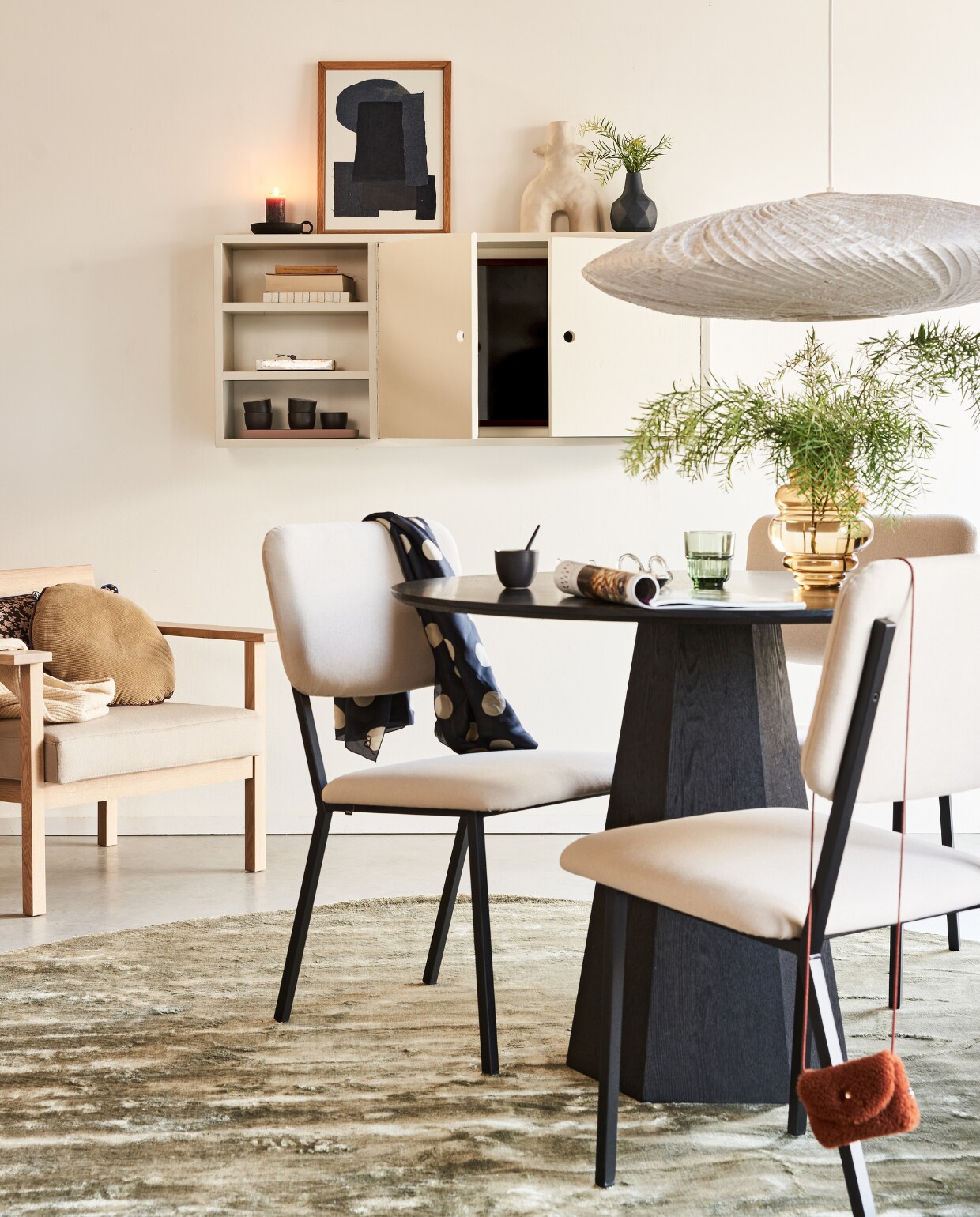 Wandkast in kleur Shaded White 201 van Farrow &amp; Ball, 122x20x53 cm (bxdxh), prijs op aanvraag (combitex.nl). Televisie The Frame, 32 inch € 429,-, verwisselbare walnoten lijst The Frame € 129,- (samsung.nl). Zwarte vaas € 35,-, paarse tray in de kast € 49,-, tafel Pilar, 100 cm (Ø) € 625,- (zuiver.nl). Zandkleurige ecomix gerecyclede vaas Twig van vtwonen, 29 cm (h) € 44,95, groen karpet van BePureHome, 250 cm (Ø) € 449,50, glazen vaas van Bloomingville, 24 cm € 35,99 (vtwonen.nl). Stoffen kunstwerk met eikenhouten lijst € 69,- (sur-atelier.nl). Eetkamerstoelen Co gestoffeerd met Olbia Sand 03, per stuk € 375,-, loungefauteuil Base, zitting gestoffeerd met Divina 3/224 van Kvadrat € 1100,- (studio-henk.nl). Corduroy kussen, 40 cm (Ø) € 35,80, bruin kussen met print van by Doris voor HKliving, 60x35 cm€ 37,95, bamboe hanglamp € 495,-(hkliving.nl). Overig privébezit. vtwonen 02-2022 | styling Esther Jostmeijer | fotografie Bart Brussee | assistentie Esther de Leeuw, Fleur Kant, Monique Vink | met medewerking van Combitex