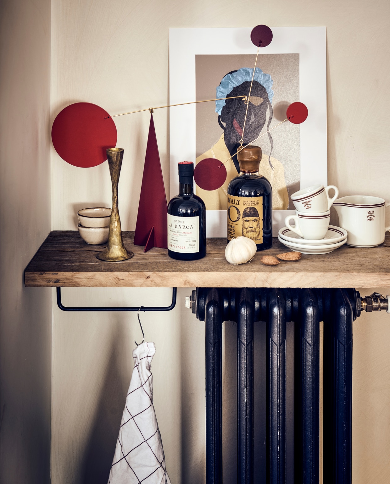 Muurverf Lime Paint in kleur Mykonos van Bauwerk (bauwerkcolour.com). Oude radiator € 95,99 (pietjonker.nl). Kommetjes per stuk € 4,99, espressokop met schotel per stuk € 3,99, melkkan € 3,99 (hm.com). Smoked olijfolie € 18,99, azijn € 12,99 (sissy-boy.com). Poster Jamali by Ana Collectives van Loods 5 Kunst, 30x40 cm € 25,-, rode mobile Kenya, 46x41 cm (bxh)  € 129,- (loods5.nl). Zwart ijzeren handdoekrek small € 16,- (thefinestore.com). Overig privébezit. vtwonen 11-2022 | styling Kim van Rossenberg | fotografie Sjoerd Eickmans | uitvoering Richard van Meerveld