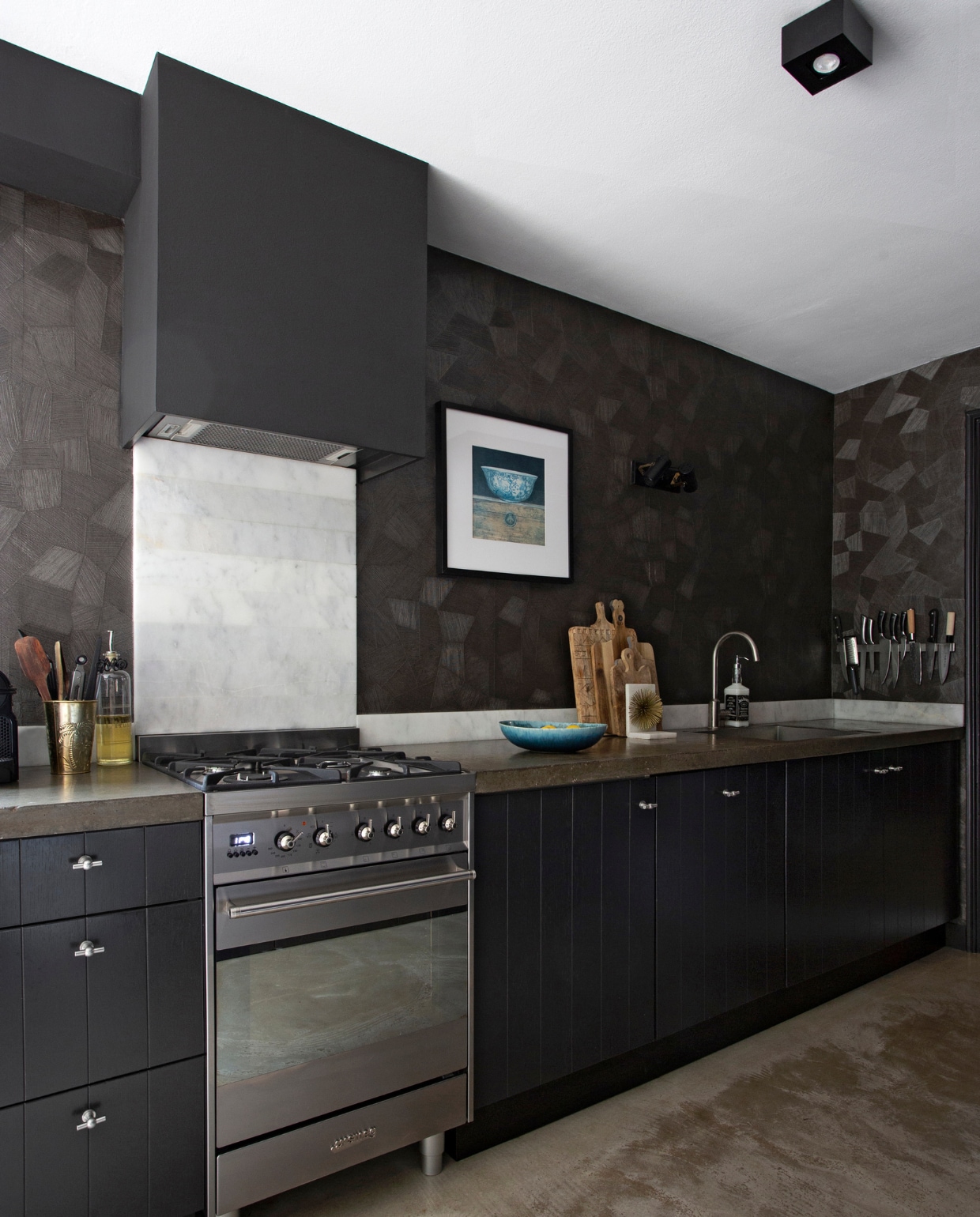 Behang Focus Arte. Plafondspot Karwei. Keuken showroom-model. Oven Smeg. Marmeren plaat Wood and Stones. Fotolijst Ikea. Gouden beker, zeeppomp Loods 5. Schaal H&amp;M Home. Snij- planken Hema, Loods 5, Dille &amp; Kamille. Boekensteun Homestock. vtwonen 06-2021 | styling Liesbeth Visschedijk | fotografie Jeltje Janmaat