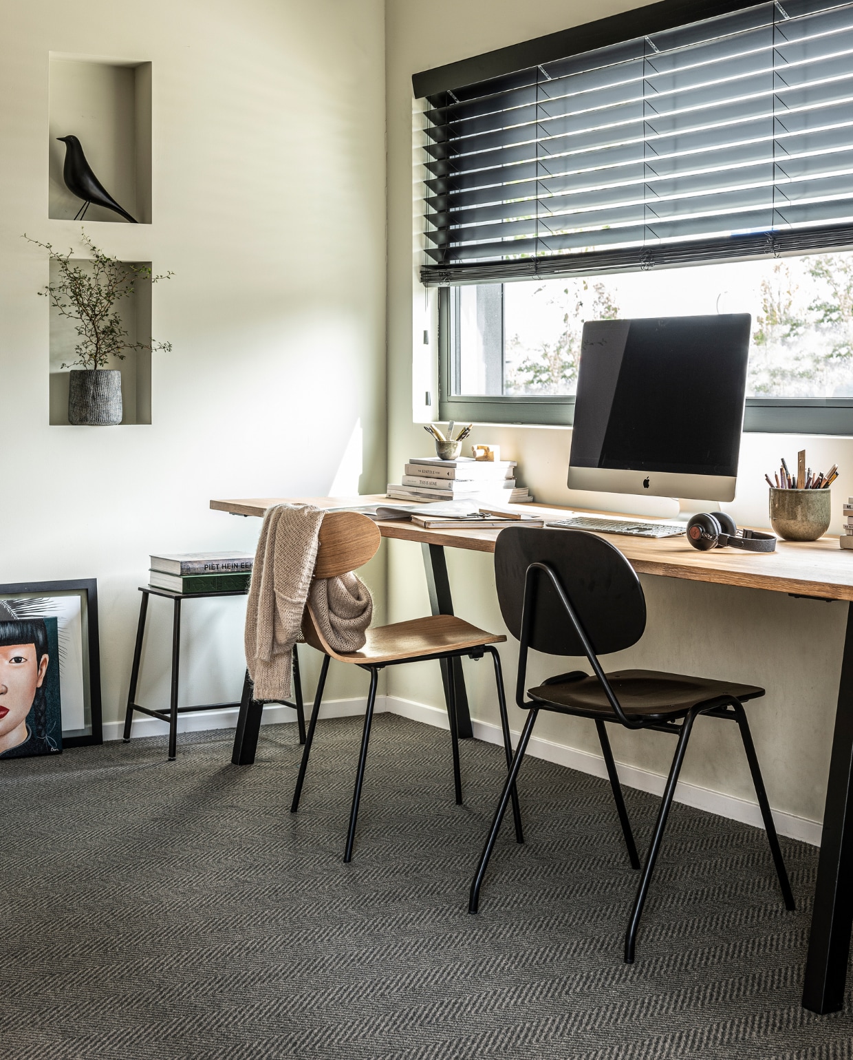 vtwonen collectie (Tapijt Herringbone Mud Grey, ook in Zinc, 400 cm breed, per strekkende meter € 169,95, vloerkleed op maat gemaakt prijsvoorbeeld 200x300 cm € 439,40). M.m.v. vtwonen.nl/vtwonen-collectie (plant en pot), vtwonen.nl (zwarte Eames vogel van Vitra), bepurehome.com (zwarte stoel, houten stoel, krukje), stories.com (vest), overig privébezit. vtwonen 22-2019 | productie Tanja Saarberg | styling Kim van Rossenberg | fotografie Sjoerd Eijckmans
