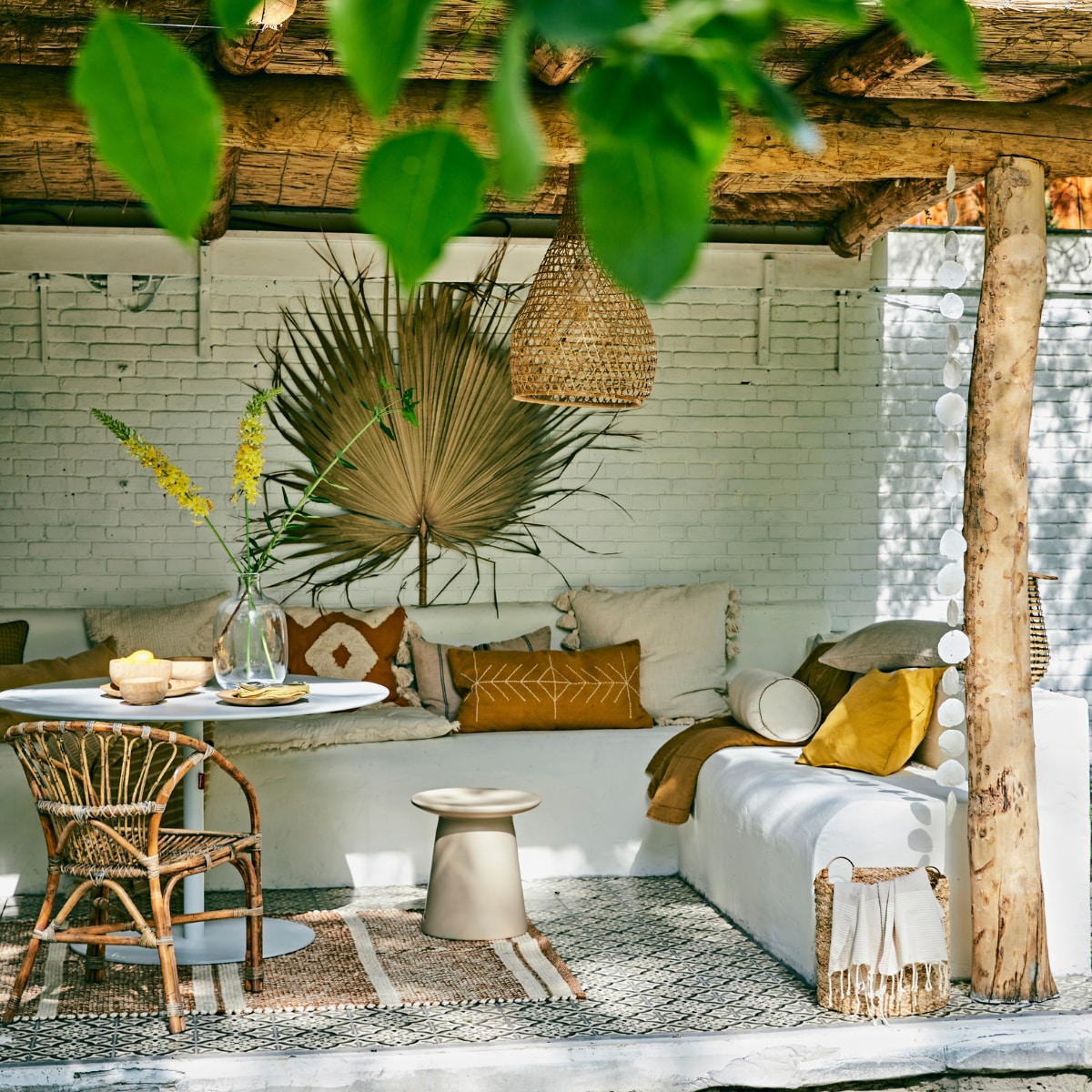 Eettafel Fatboy Formitable xl, Ø 120 cm € 595,-, mandenset Banana van Urban Nature Culture € 75,85, bijzettafel Earthenware van HKliving € 199,-, houten schalen Mango van Urban Nature Culture, set van 3 € 22,95, houten borden van Urban Nature Culture, Ø 23 cm € 14,25 (vtwonen.nl). Palmblad € 22,-, wit kussen met franjes, 50x50 cm € 55,25, okergeel kussen met borduursel, 70x40 cm € 53,-, wit linnen rolkussen, 20x50 cm € 39,25, okergeel geruit kussen, 50x50 cm € 28,95, gestreept linnen kussen, 40x60 cm € 37,95, groot kussen met kwasten, 60x60 cm € 58,50, wit matraskussen met rafels, 70x180 cm € 86,25 (madamstoltz.dk). Okergeel en zandkleurig linnen kussen € 34,95, okergeel quilt € 72,-, glazen flesvaas € 55,- (iblaursen.nl). Okergeel met wit kussen met kwasten, 50x50 cm € 24,99, gele linnen kussenhoes, 50x50 cm € 9,99, vloerkleed 140x200 cm € 179,-, geel gestreepte hamamdoek in de boom € 9,99 (hm.com). Gele servetten € 6,20 (nordal.eu). Overig privébezit. vtwonen 07-2020 | styling Cleo Scheulderman | fotografie Jeroen van der Spek