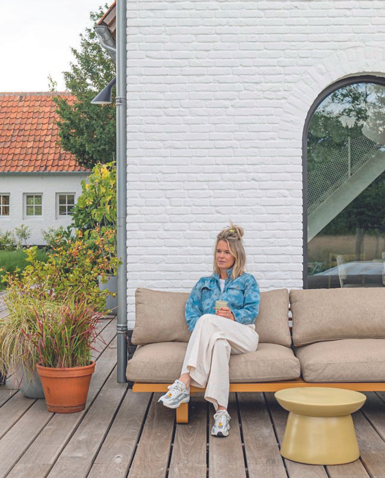 Tuinbank, kussens en bijzettafel HKliving. vtwonen 08-2024 | styling Jeske Weel | fotografie Caroline Coehorst