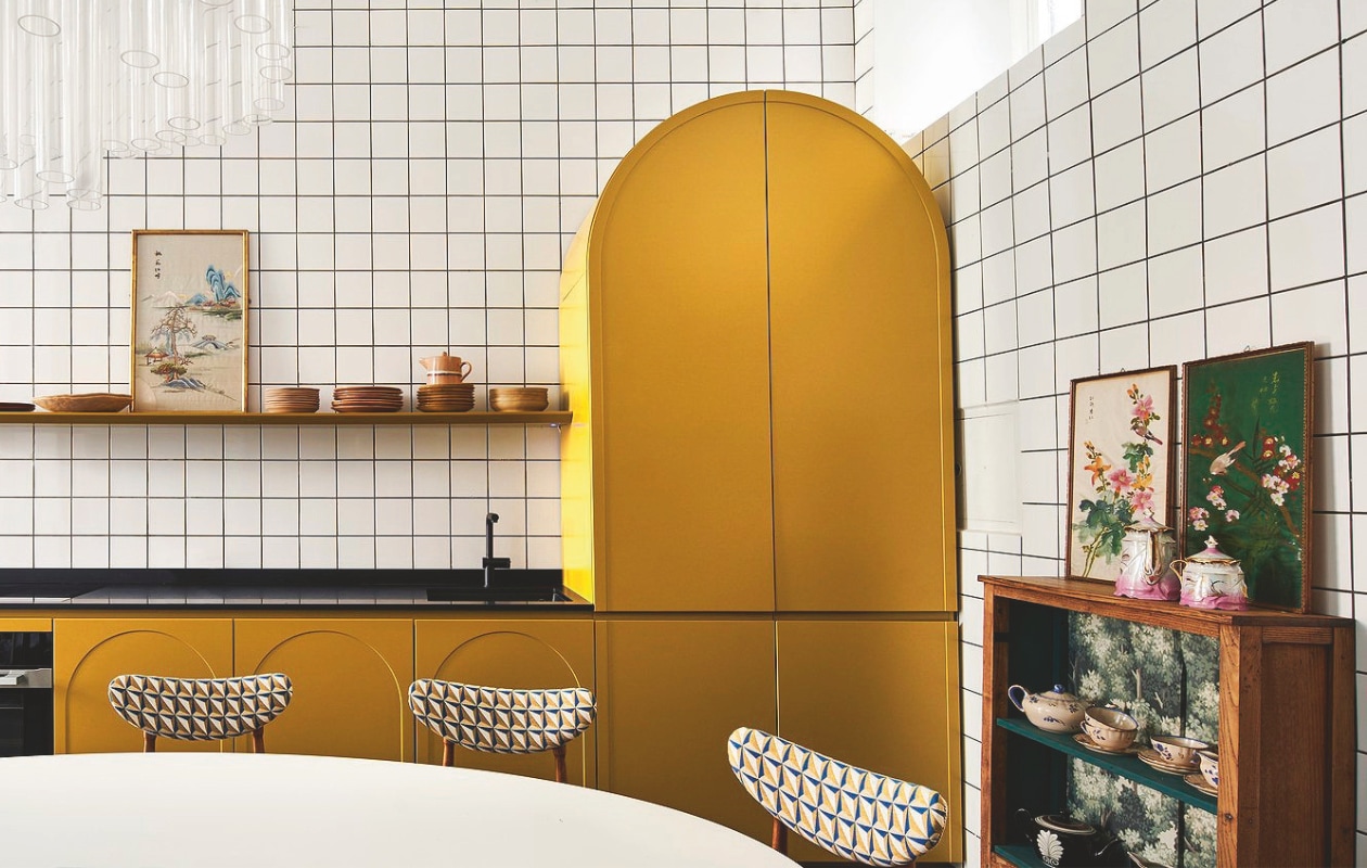 Keuken eigen ontwerp. Tafel en gestoffeerde stoelen Nap Atelier. Servieskast, kroonluchter en kunstwerken vintage. vtwonen 09-2024 | styling Francesca Davoli | fotografie Fabrizio Cicconi