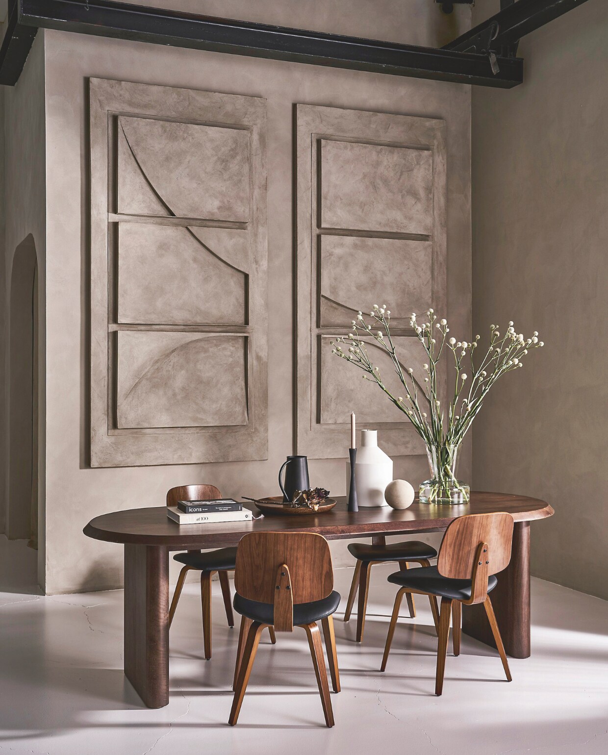 Mangohouten eettafel Ellips in walnoot, vanaf 180x90x75 cm (lxbxh) € 1299,-.Eetkamerstoel Classic in bruin en zwart, kunstleer en walnoothout, 50x48x81 cm (bxdxh) € 149,-. Metalen kan met handvat 10/15x23 cm (Øxh) € 24,95. Mangohouten bord, vanaf 20,5 cm (Ø) € 16,95. Metalen kandelaar in matzwart, 30 cm (h) € 29,95. Metalen vaas, 24x38 cm (Øxh) € 59,95. Glazen vaas, 26x30 cm (Øxh) € 79,95.M.m.v. artinreturn.nl (schilderijen), thefarm-shop.nl (verf muur Shady Silt). Overig privébezit. vtwonen 10-2024 | styling Cleo Scheulderman | fotografie Jeroen van der Spek