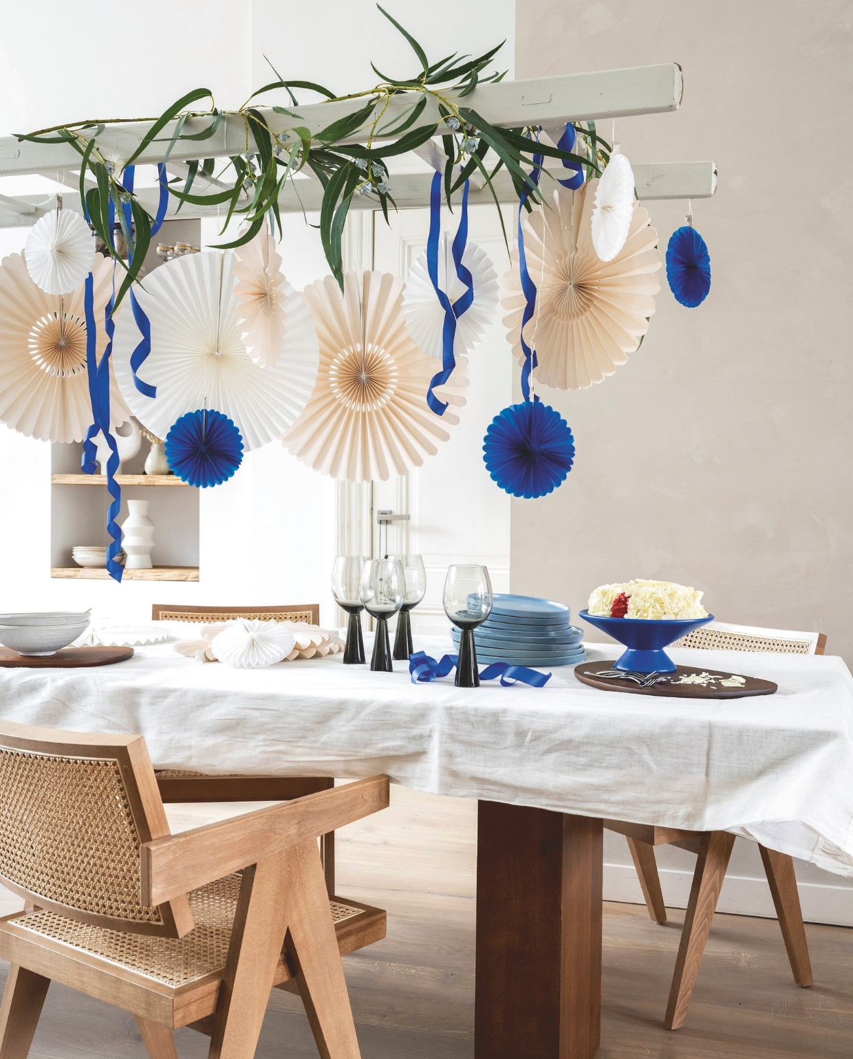 Wijnglazen Cone Smoke € 17,95 (thejameshaarlem.com). Lichtblauwe porseleinen borden Fjord van Villa Collection, set van 2 vanaf € 22,95, essenhouten snijplanken Cairn van Ferm Living, set van 3 € 139,- (vtwonen.nl/shop). Papieren waaiers vanaf € 1,15 (party- winkel.nl). Overig privébezit. vtwonen 10-2024 | styling Kelly van Gendt | fotografie Stan Koolen