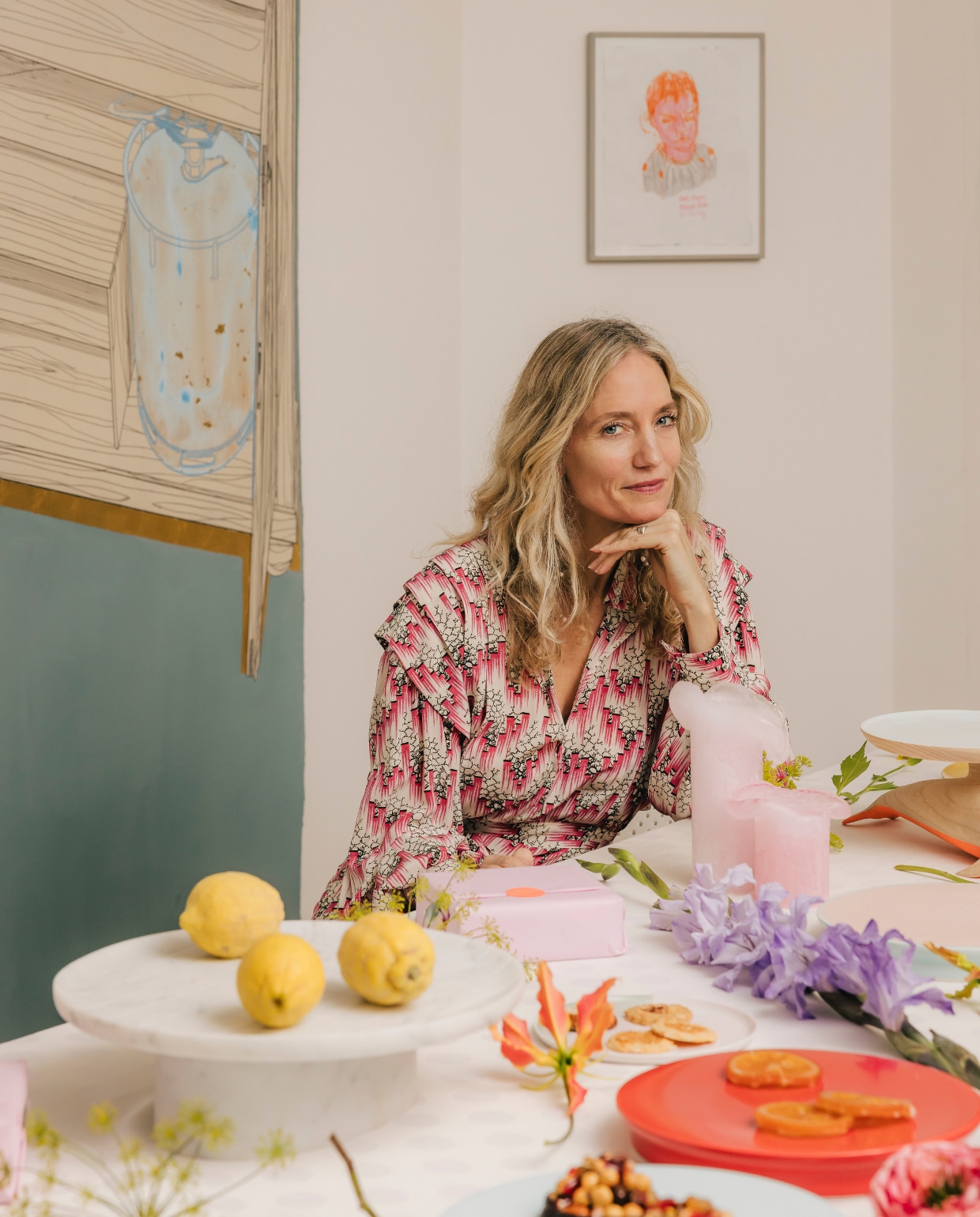 Carole in haar eetkamer waar ze regelmatig diners geeft. ‘Door bloemen los op tafel te leggen, creëer je een extra feestelijk gevoel.’ Het schilderij is van kunstenaar Mathieu Meijers. stijlvol wonen 08-2024 | fotografie Katoo Peeters | tekst Tanne Donjacour Gielen