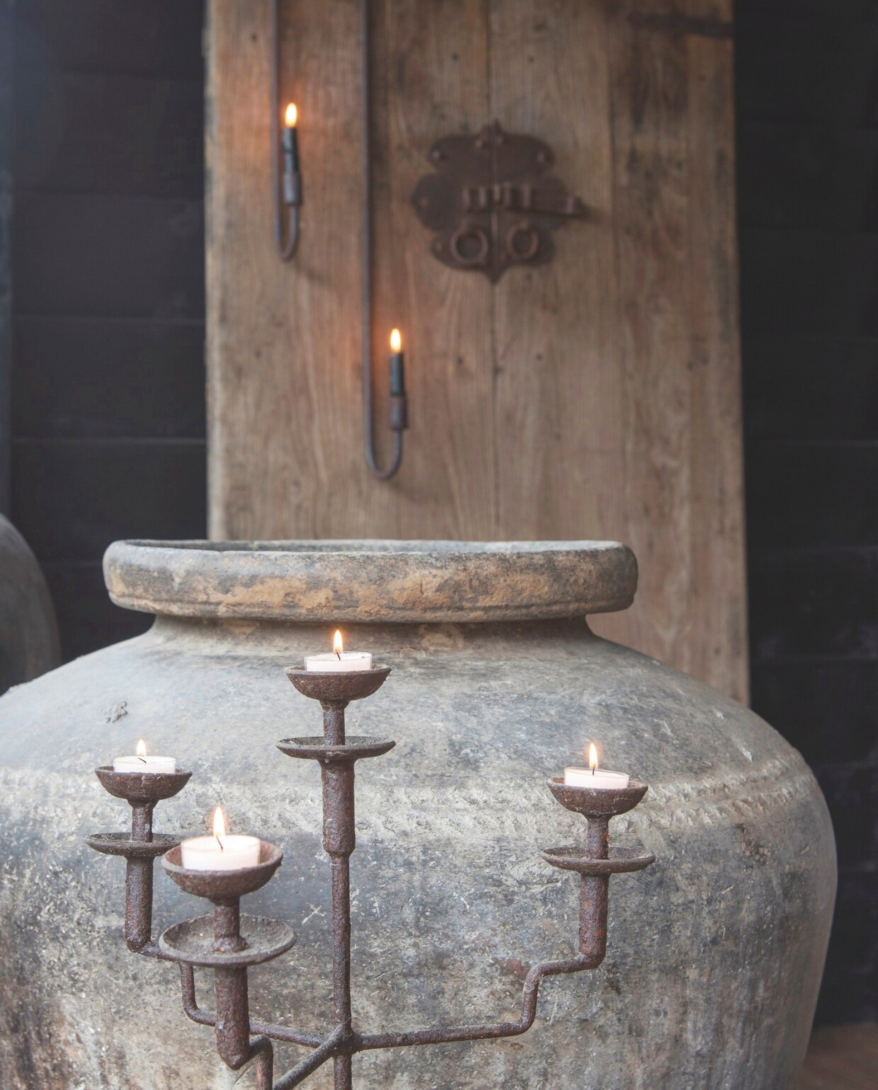 Met hun verweerde uiterlijk lijken de stoere kandelaars van De Buitenkans gemaakt voordeze naturel  omgeving. vtwonen landelijk 08-2024 | styling Peet! Styling | fotografie Joyce Vloet