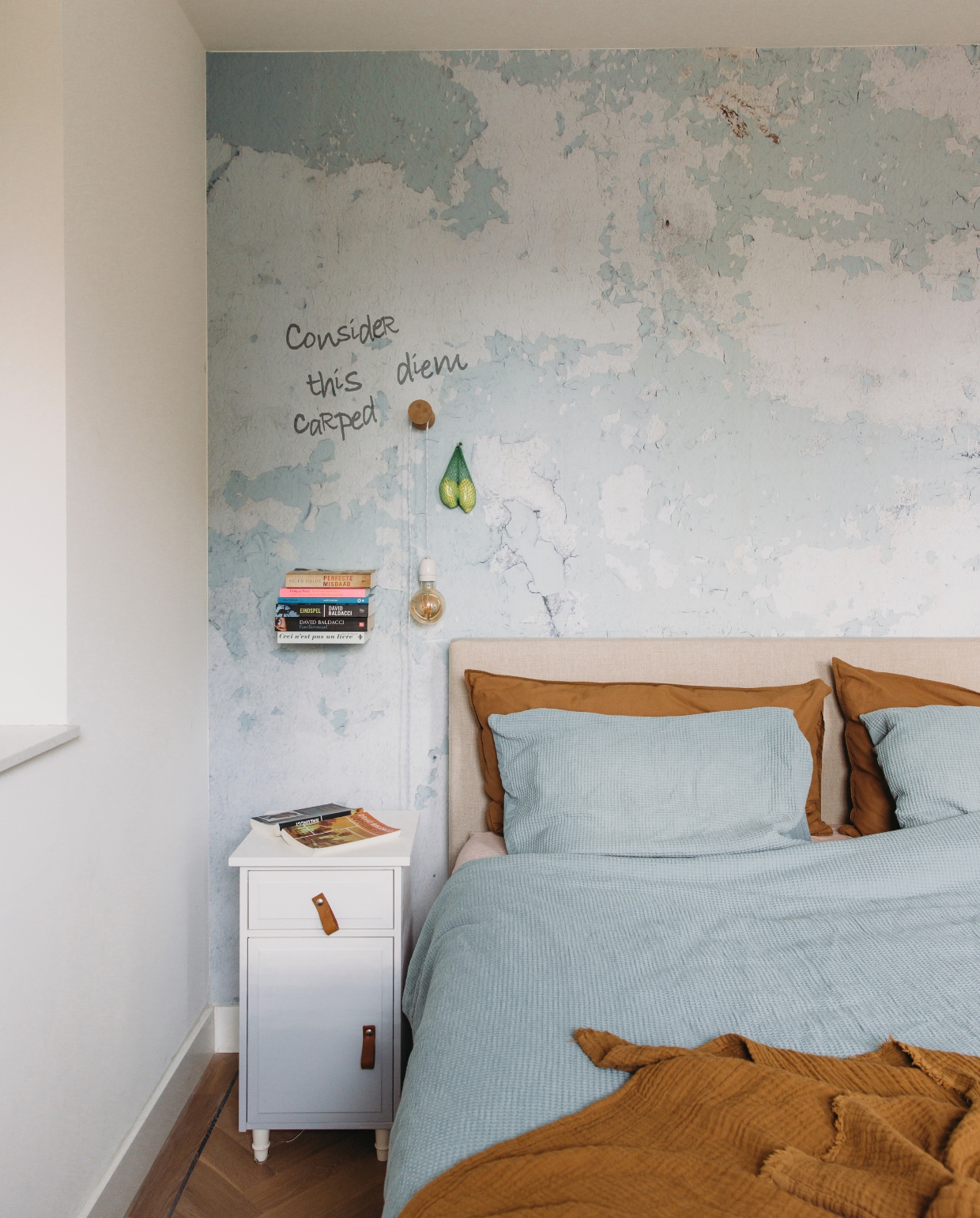 Bed Scapa Home. Geverfde nachtkast Ikea. Uitvergrote foto als behang repro.nl. Boekenplank Selfshelf. Dekbedovertrek Hema. Lamp DIY. vtwonen DIY-special 11-2024 | styling en productie Agnes Verduin |  fotografie Eva Bloem