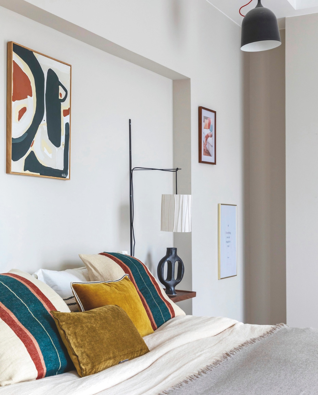 Bedlinnen en plaid Maison de Vacances. Fluwelen kussens Élitis. Gestreepte kussenslopen Libeco. Bedlamp en hanglamp Voyages Déco. Het kunstwerk is van Charlotte Virfolet. Stijlvol Wonen 01-2025 | styling Marie-Maud Levron | fotografie Cecile Perrinet-Lhermitte | productie en brontekst AC Scoffoni
