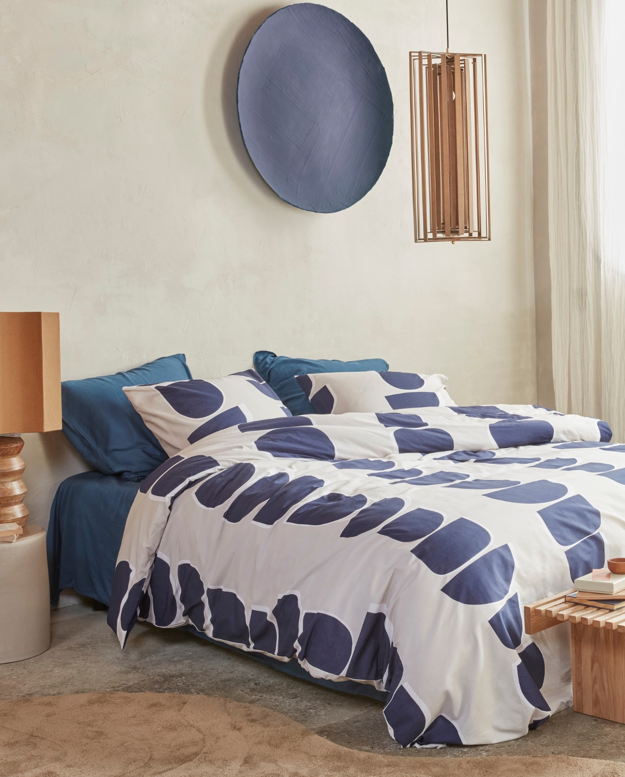 Katoenen dekbedovertrek Moons in Indigo vanaf € 49,95. Katoenfluwelen sierkussen Broom Bow in Naturel, 40x60 cm € 49,95. M.m.v. shop.vtwonen.nl (kruk Serax, kleed Woood), loods5.nl (tafellamp, bank), letoile.store (mok, notitieboekjes, wierookhouder), paviljoennoord.com (dienbladen, kandelaar, bord, karaf). Overig privébezit. vtwonen 04-2025 | styling Kim Timmerman, Danielle Verheul | fotografie Richard Smit