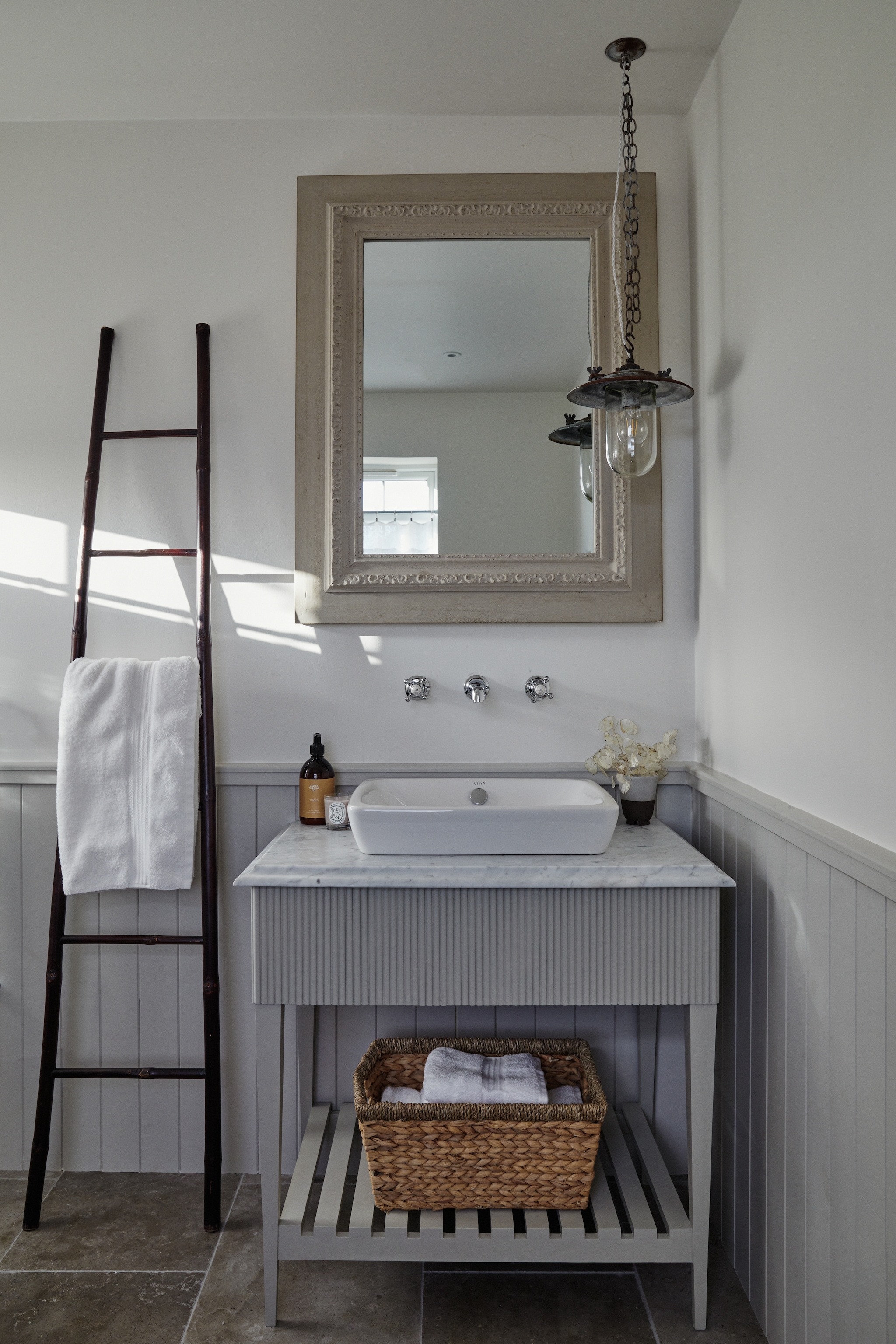 op lambrisering Blackened van Farrow & Ball, scheepslamp Alessio van Las Sola, spiegel Barok Spiegel, trap Zara Home. vtwonen Landelijk 9-2025 | productie Living Inside | styling Ali Heath | fotografie Brent Darby