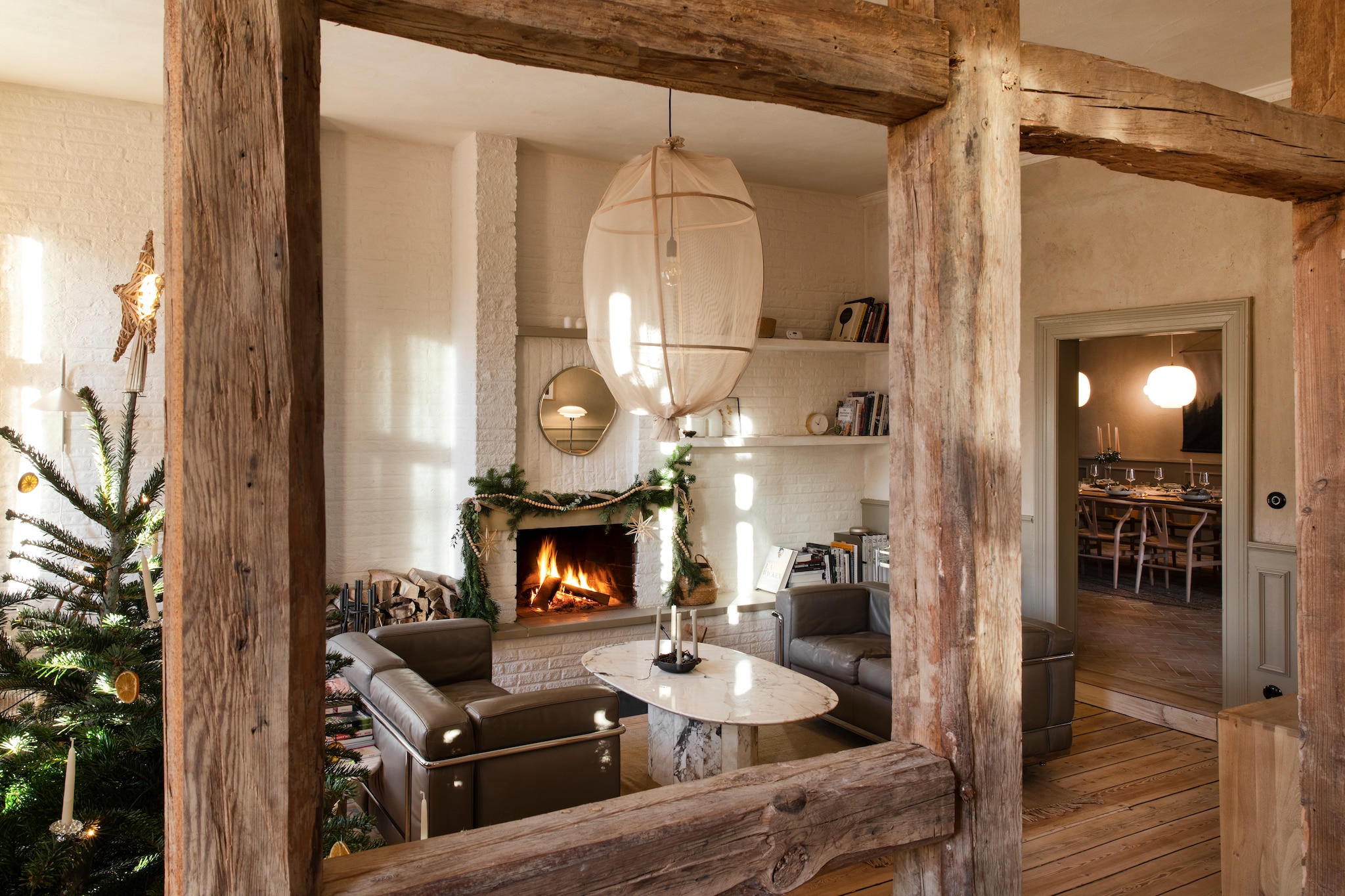 Banken LC2 van Le Corbusier voor Cassina zijn familiestukken. Marmeren salontafel via tweedehandswinkel, soortgelijke via Marktplaats, Whoppah of Reliving. Organische spiegel Zara Home. Hanglamp zelfgemaakt. De muur van metselwerk werd gewit voor een frissere sfeer. vtwonen Landelijk 11-2025 | styling Miriam Hannemann | fotografie André Reuter